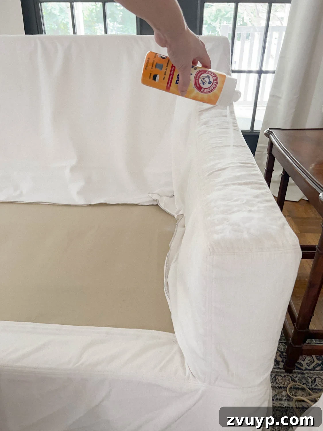 Revive Your Fabric Furniture The Ultimate Upholstery Deep Clean 9 Baking soda generously sprinkled on the surface of a couch to absorb odors and refresh the fabric.