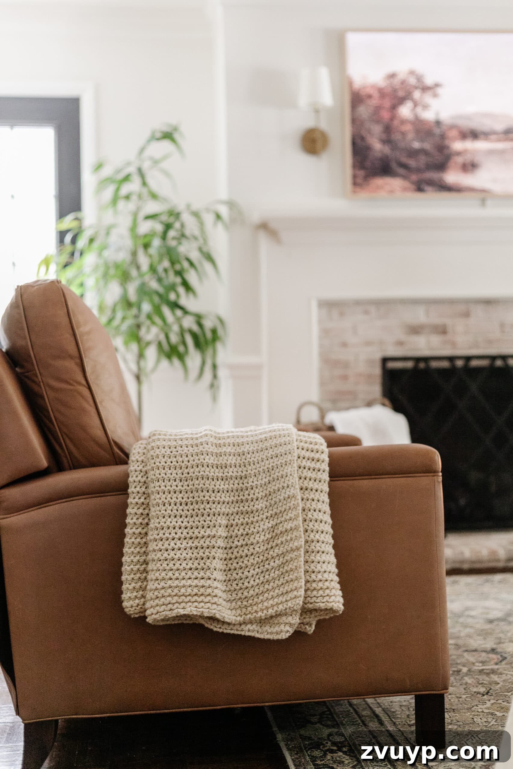 leather recliner with knit throw blanket in a living room for fall decor