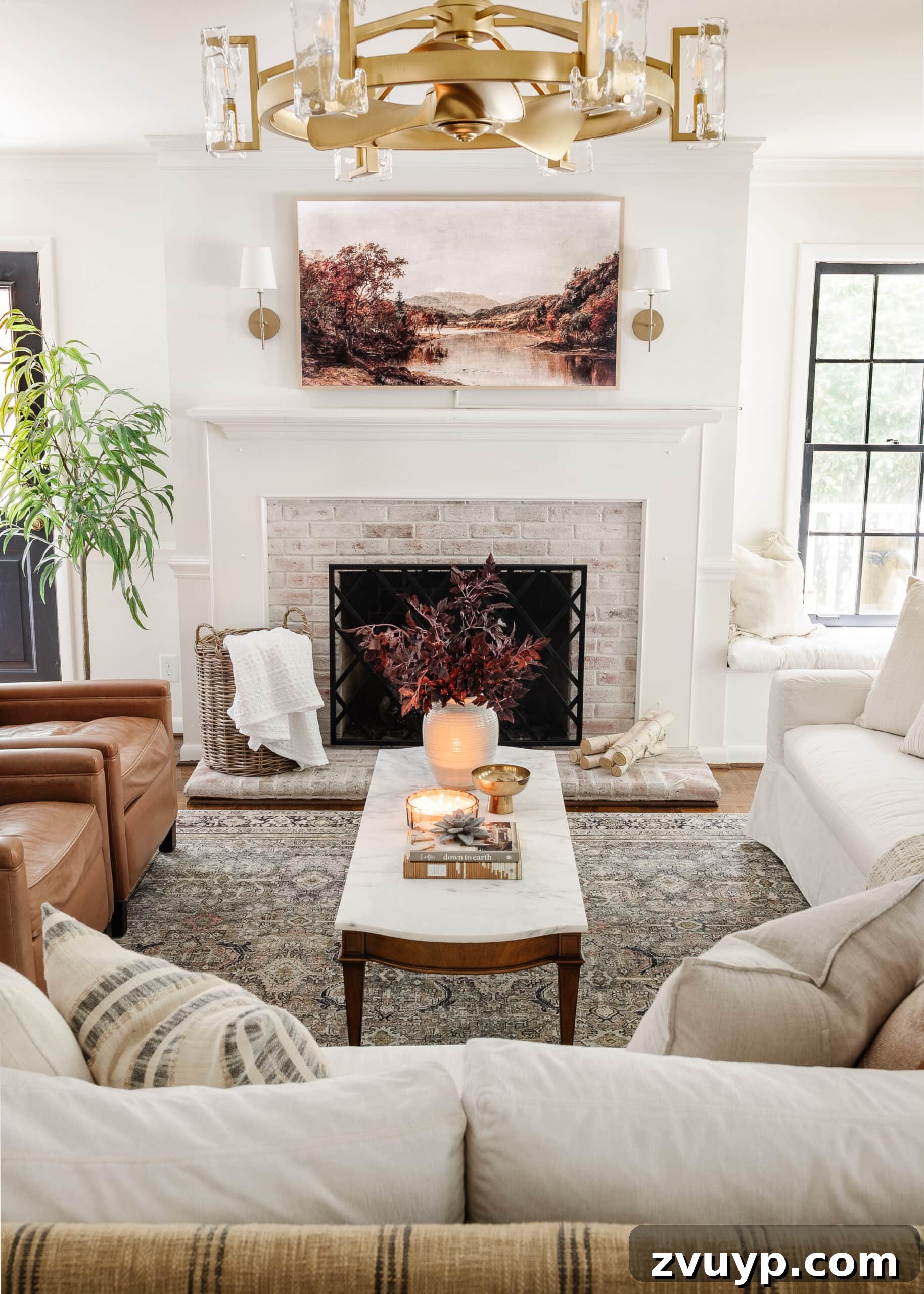 fall living room decorating ideas using soft lighting, fall art, fall leaves, and neutral pillows