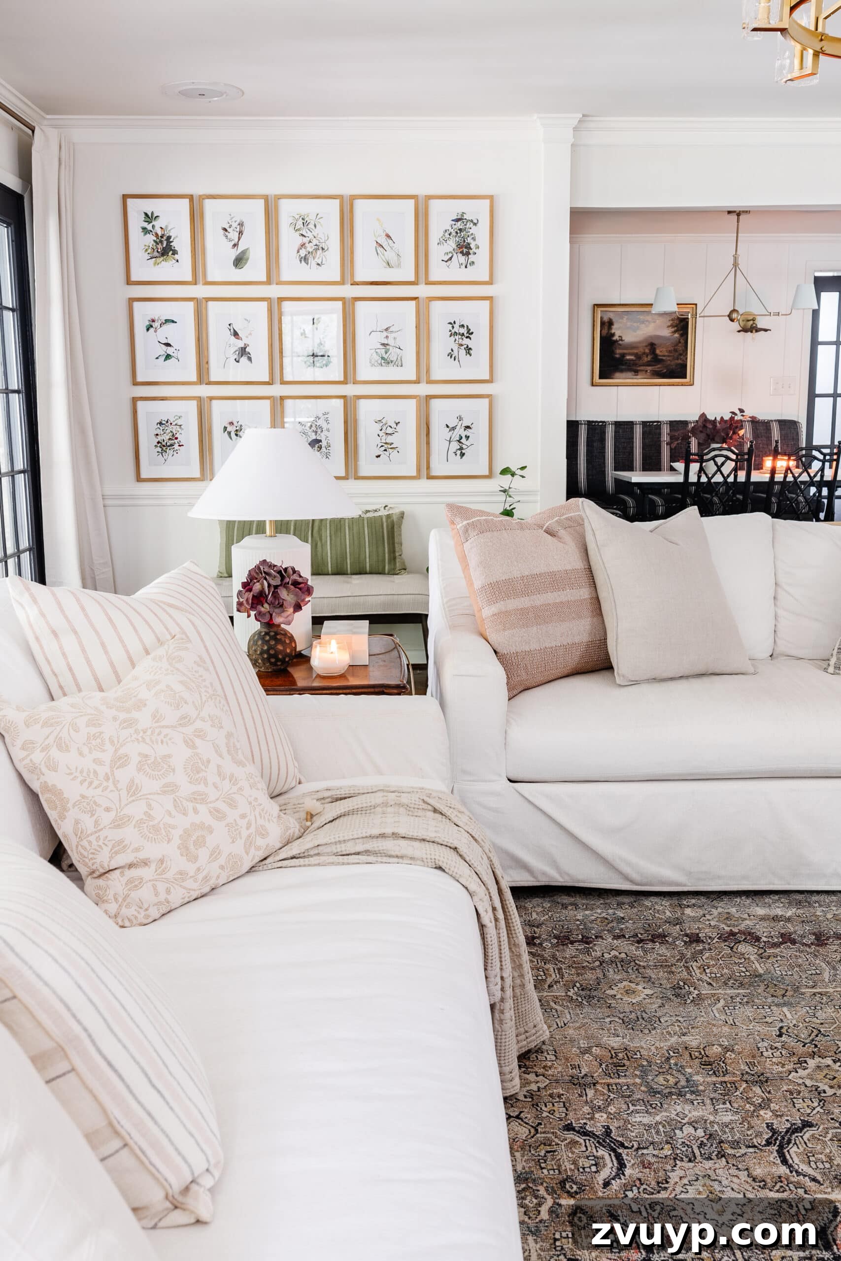 fall decorating ideas for living room with white sofas, lamps, and picture frame gallery wall