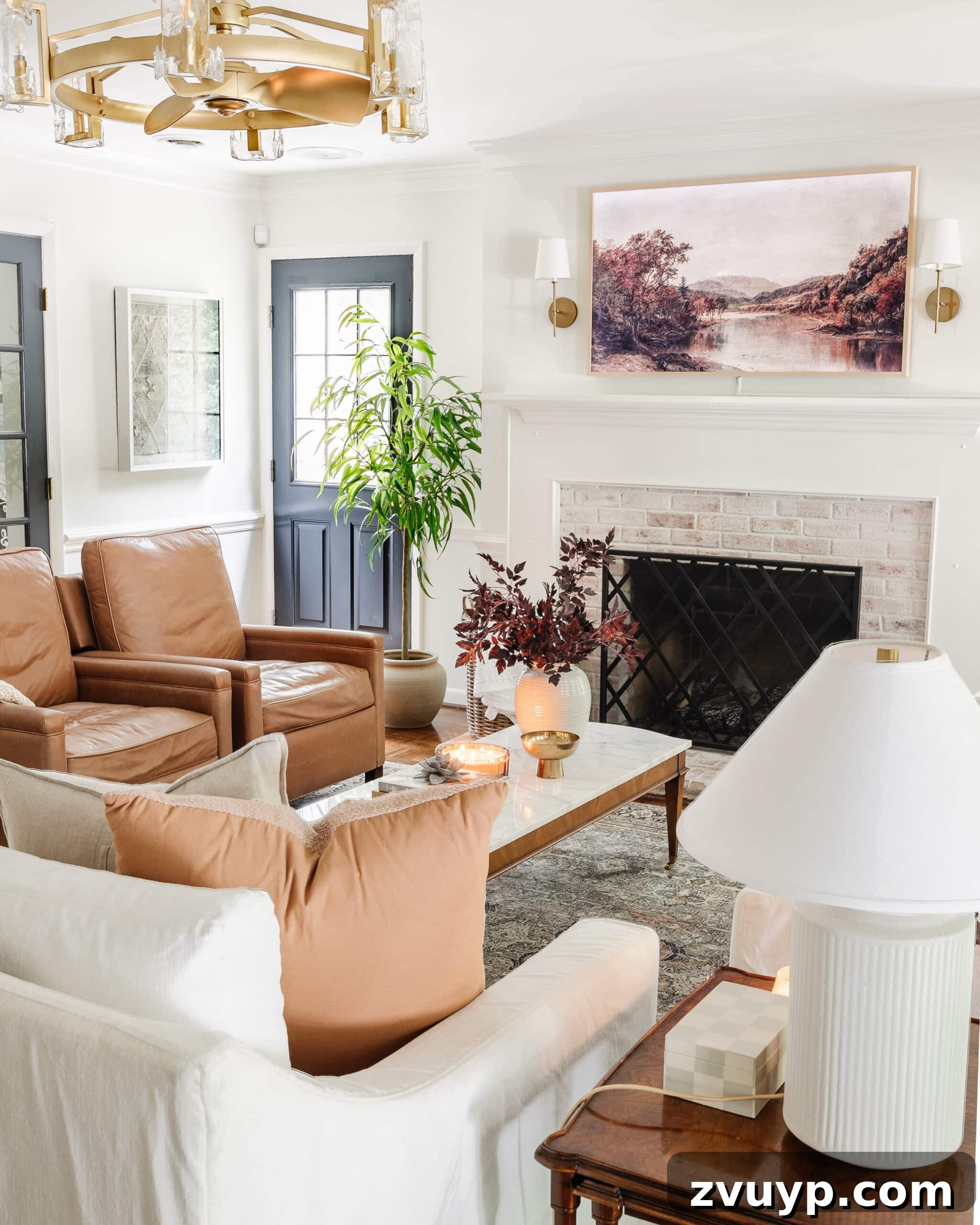fall decorating ideas for a living room with vase of fall stems, fall art on a TV, and leather recliners