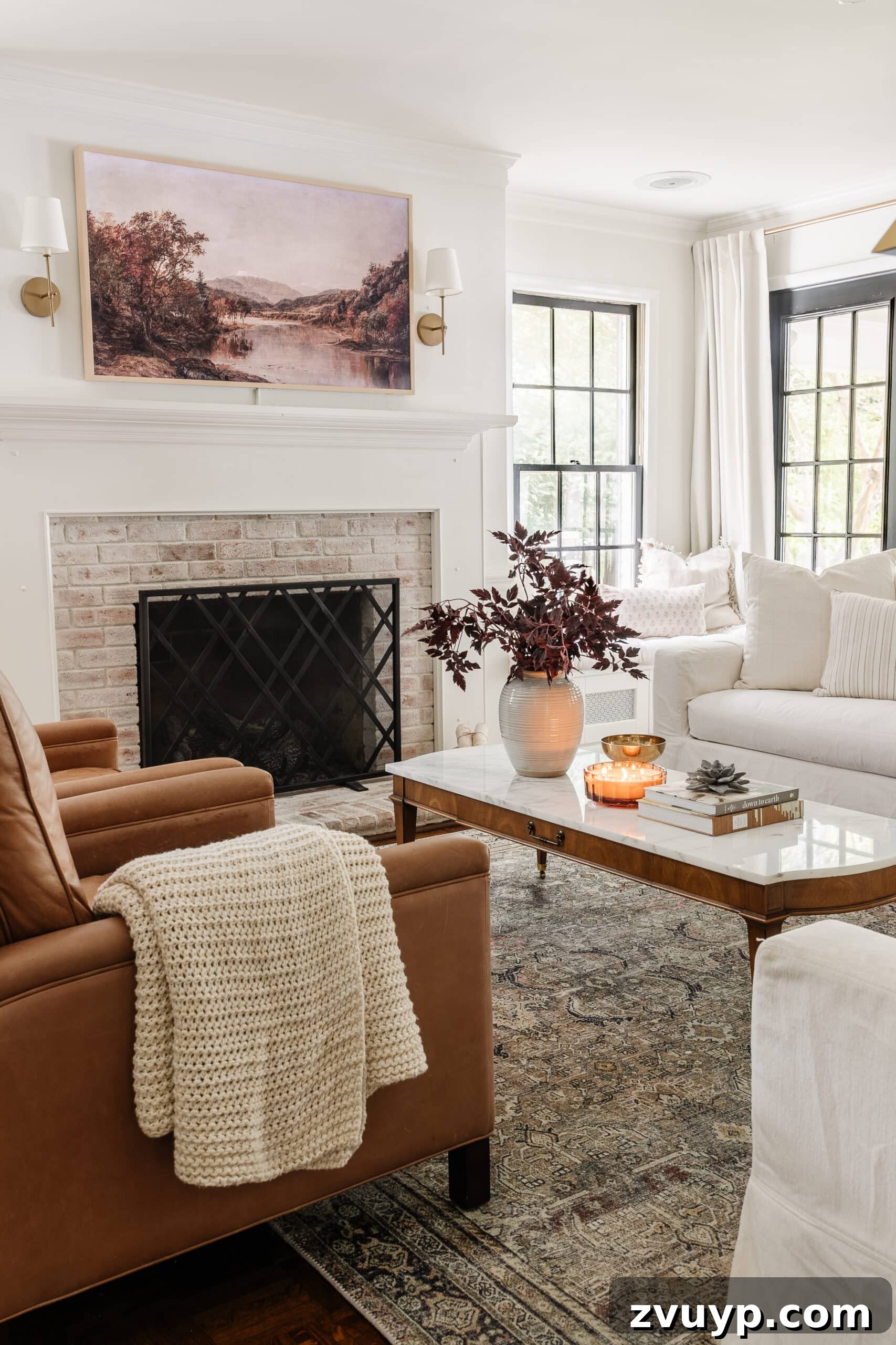 fall living room decor with fall TV art and a vase of leafy stems