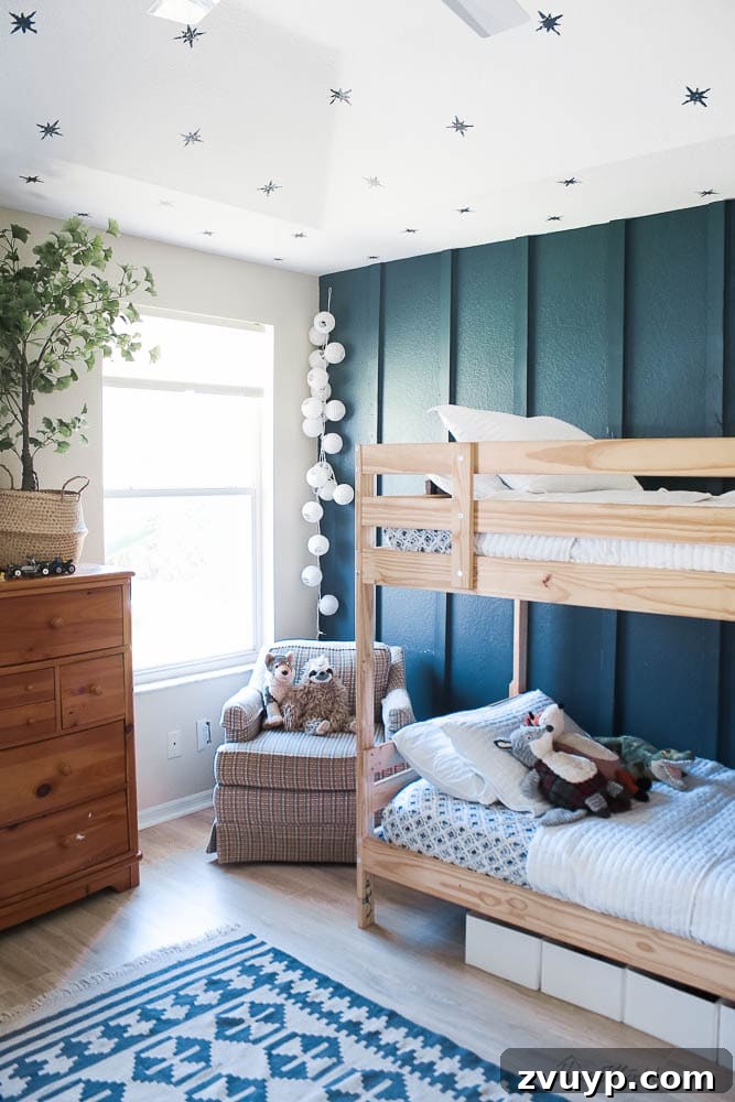 Smart Bunk Beds to Maximize Small Bedrooms 20 Board and batten wall in a small bedroom with a decorative wallpaper ceiling, creating depth and character around the bunk bed.