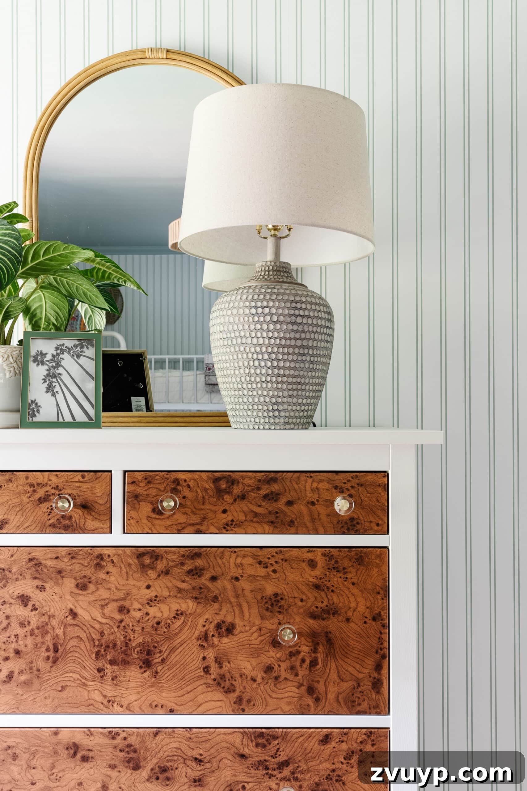Ultimate Triple Bunk Beach Pad for Teens 18 table lamp on IKEA dresser with rattan mirror, potted plant, and picture frame