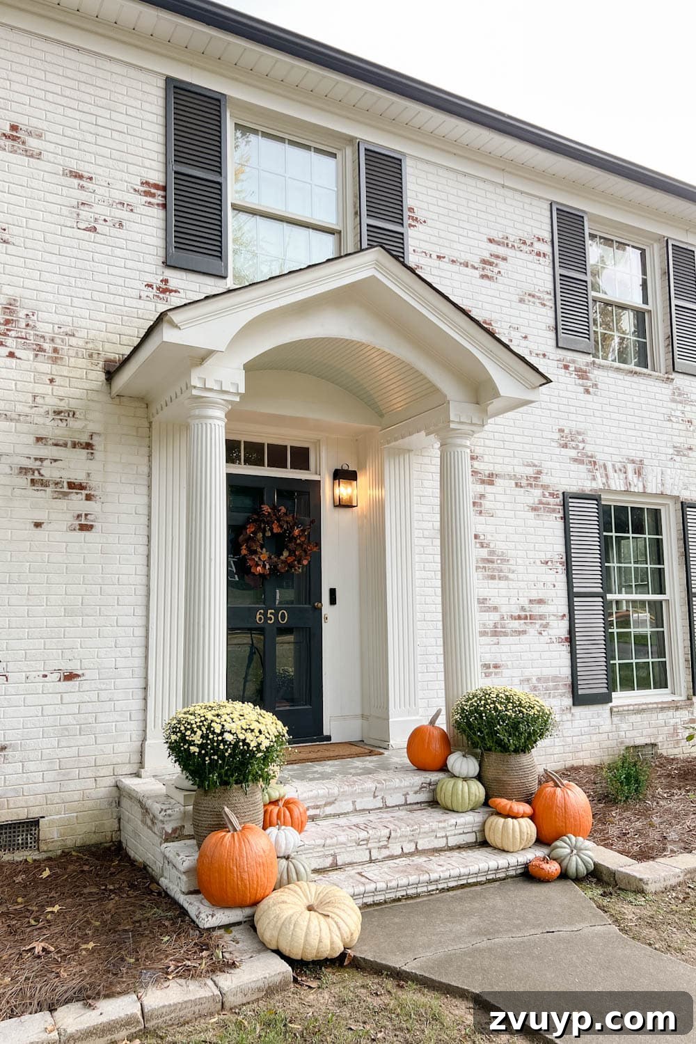 Unbelievably Real: The Best Artificial Pumpkins of 2024 5 fall front porch on a limewashed brick colonial house with artificial pumpkins on steps
