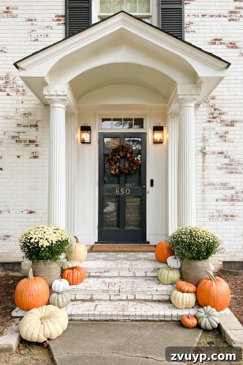 Unbelievably Real: The Best Artificial Pumpkins of 2024 6 fall front porch with potted mums, wreath, and realistic fake pumpkins on steps
