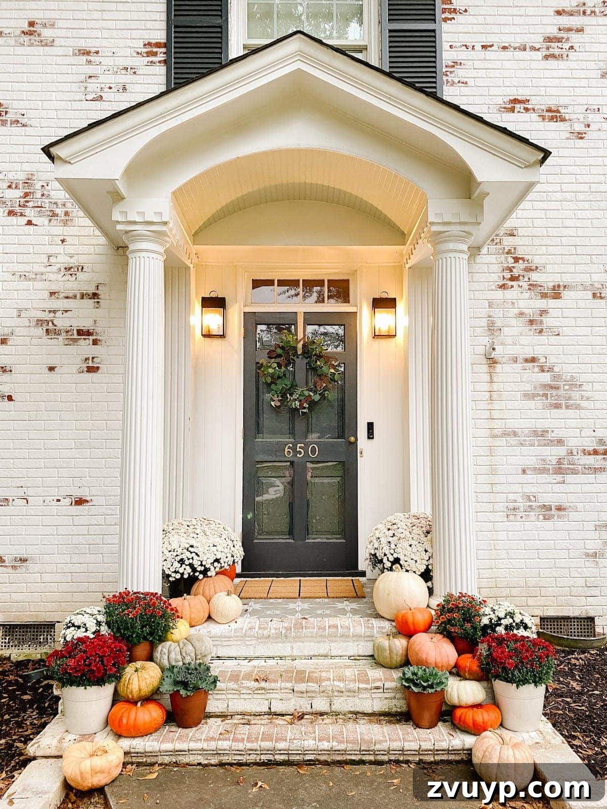 Unbelievably Real: The Best Artificial Pumpkins of 2024 2 fall porch decor around a front door with real heirloom pumpkins and fall colored mums
