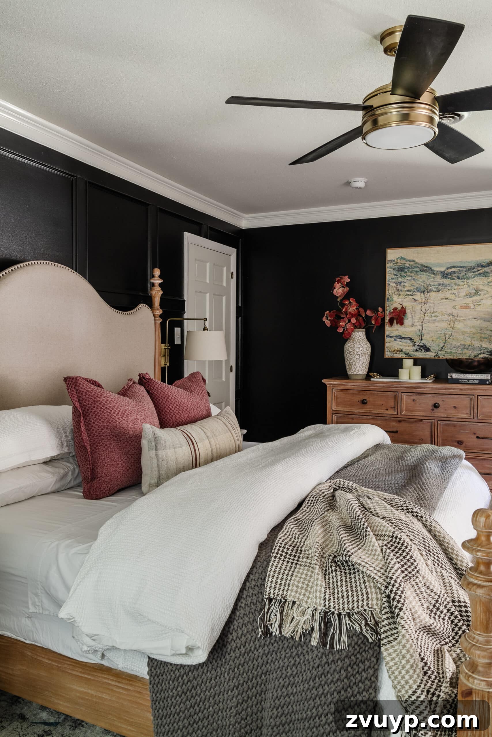 Sweet Dreams on a Budget: 10 Cozy Bedroom Tips for Ultimate Rest 2 A deeply cozy bedroom featuring sophisticated black walls, luxuriously soft bedding, and a warm wooden dresser, embodying high-end style on a budget.