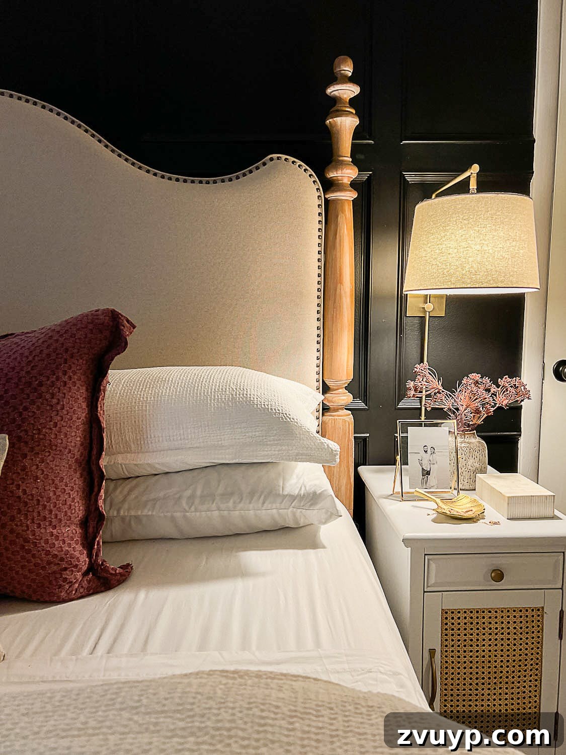 Sweet Dreams on a Budget: 10 Cozy Bedroom Tips for Ultimate Rest 13 A serene bedroom showcasing soft, warm lighting, luxurious bedding, and a thoughtfully decorated nightstand, all contributing to an effortlessly cozy and high-end aesthetic.