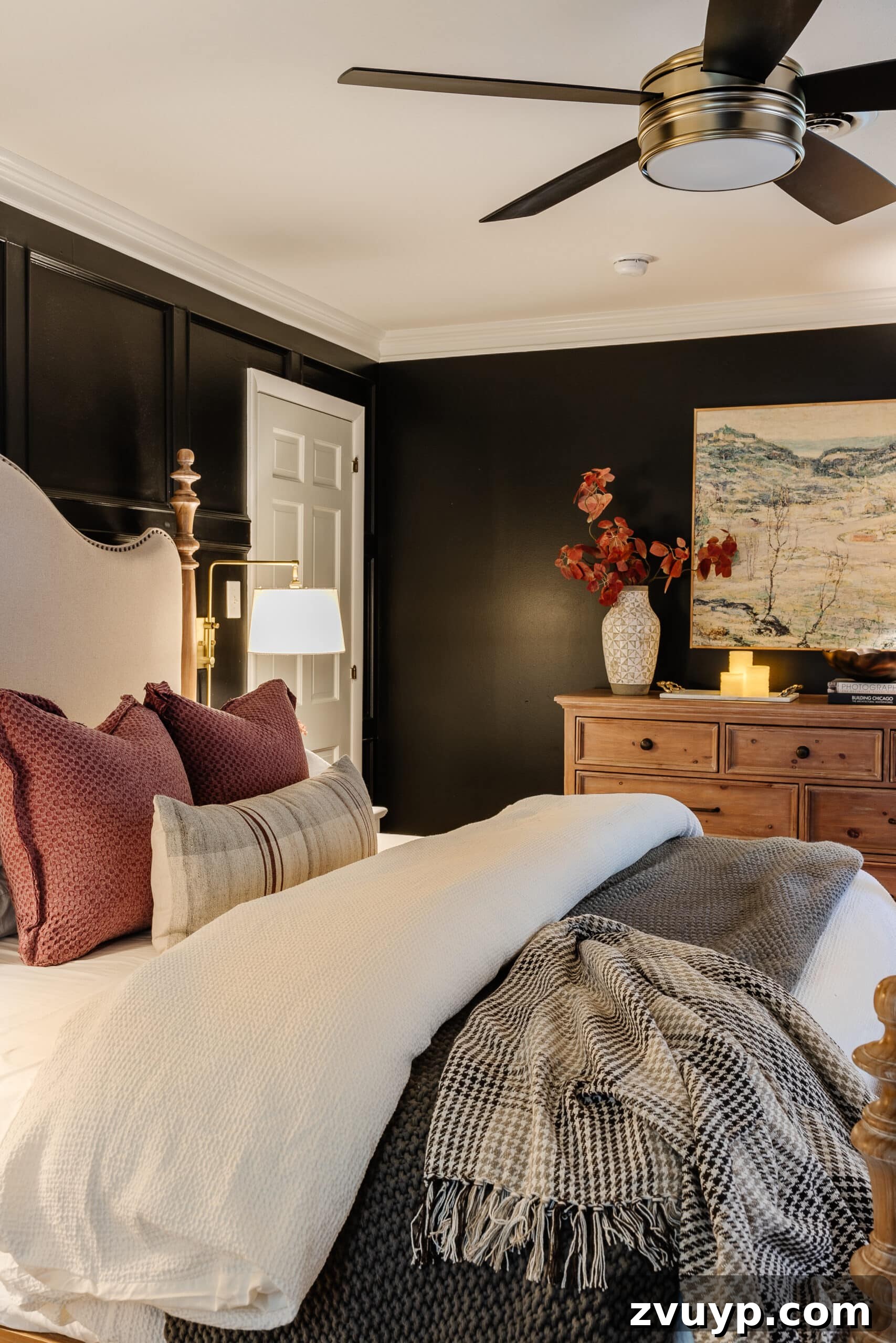 Sweet Dreams on a Budget: 10 Cozy Bedroom Tips for Ultimate Rest 6 A beautifully appointed cozy bedroom adorned with elegant lamps, soft candlelight, tasteful art, and charming fall decor elements, creating a warm and inviting atmosphere.