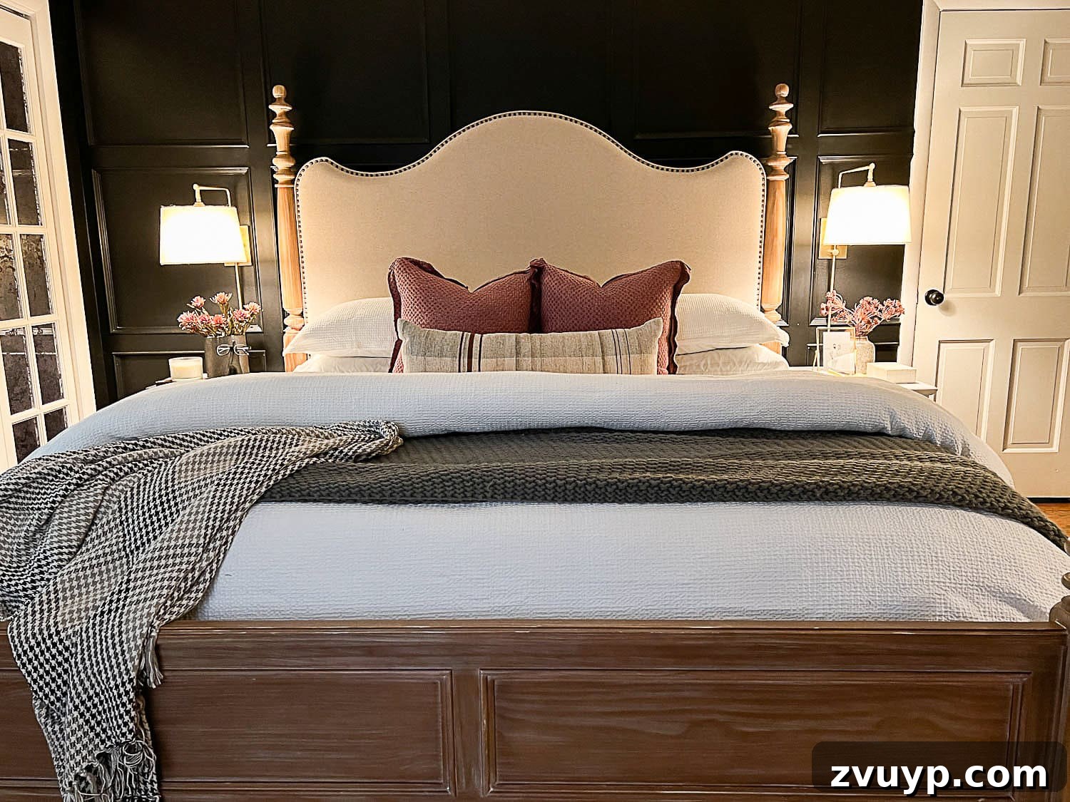 Sweet Dreams on a Budget: 10 Cozy Bedroom Tips for Ultimate Rest 7 A beautifully styled primary bedroom featuring plush, luxurious bedding, inviting wall sconce bedside lamps, and thoughtfully chosen cozy decor, creating a serene and elegant retreat.