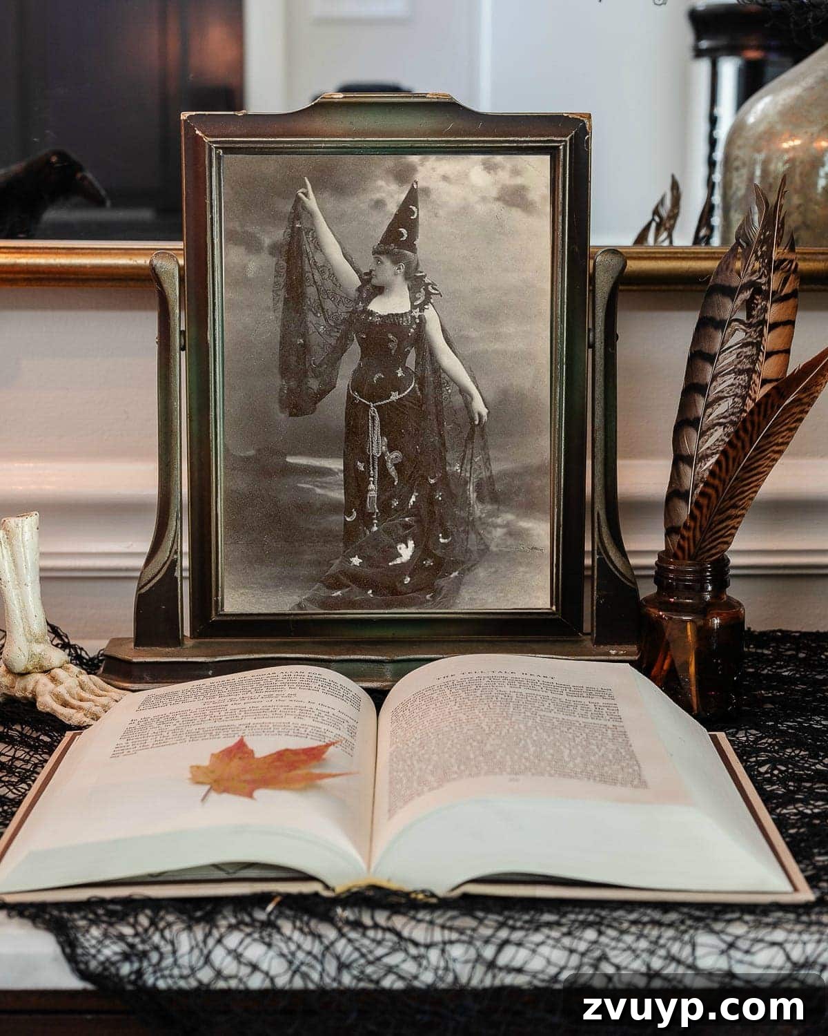 Sophisticated Scares: 30 Vintage Halloween Decor Must-Haves 5 vintage halloween portrait art in an antique picture frame with old book, ink well, and black fabric