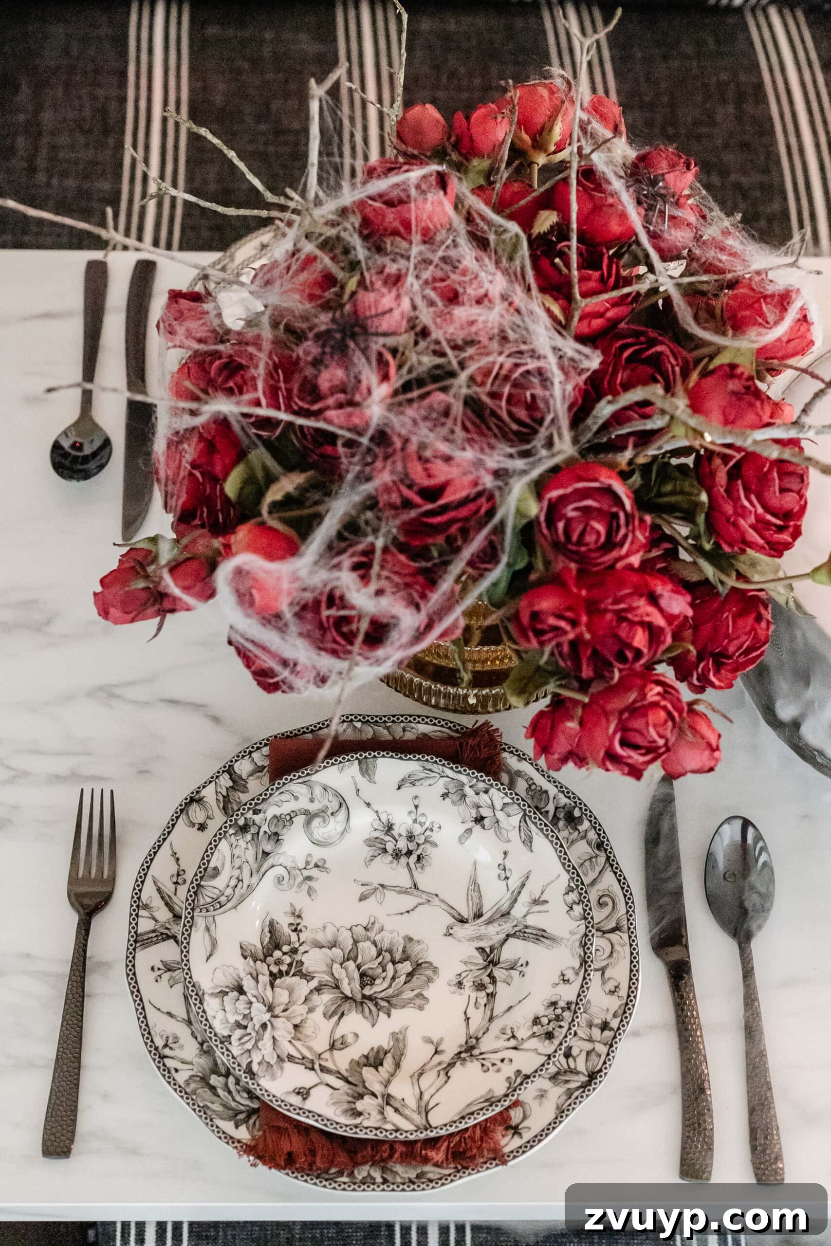 Killer Tablescapes for Your Halloween Murder Mystery 13 black toile plates and hammered black flatware Halloween place setting