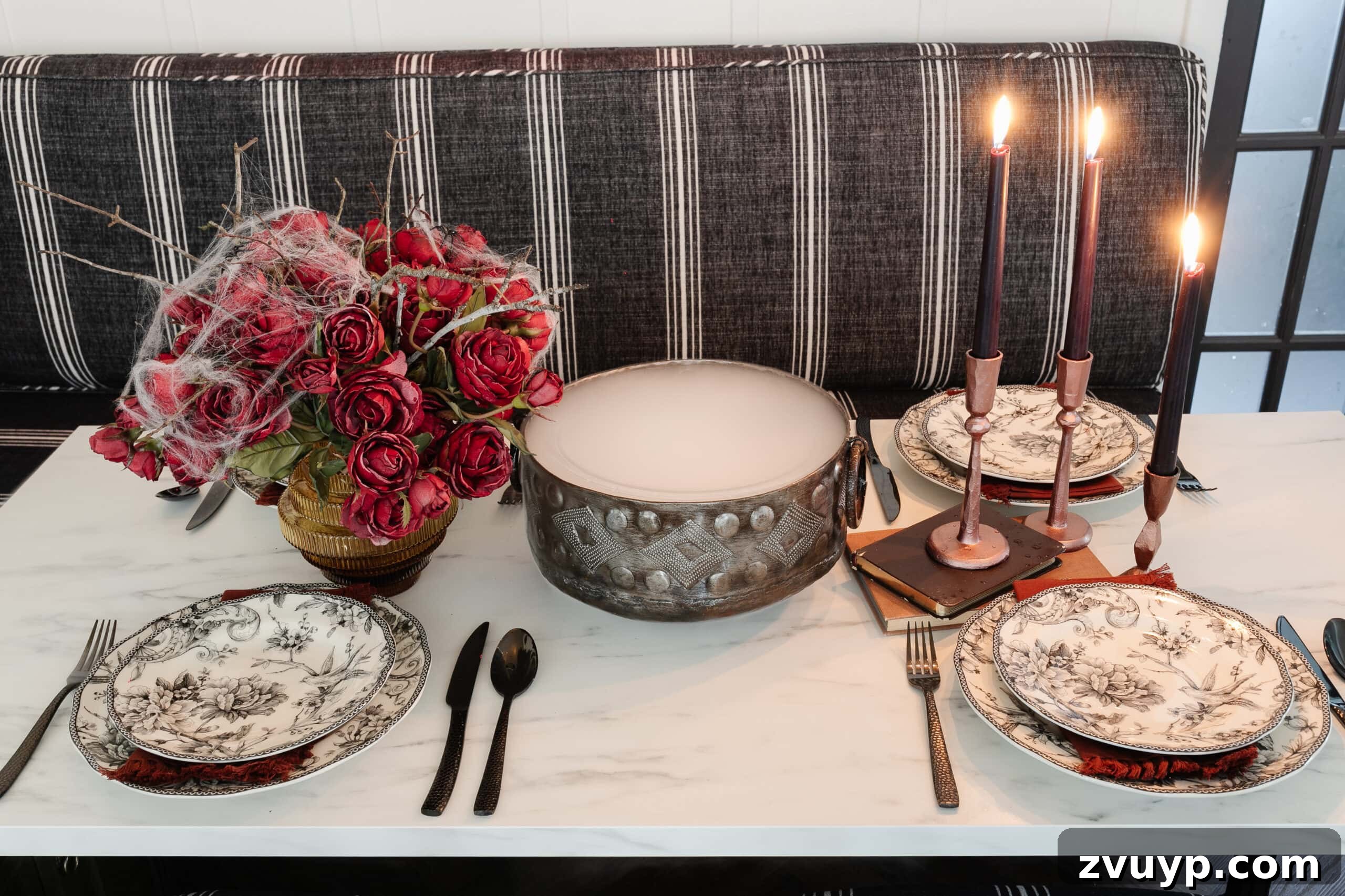 Killer Tablescapes for Your Halloween Murder Mystery 15 Halloween table decor with bowl of dry ice fog, red roses with spider webs, and black toile dinnerware