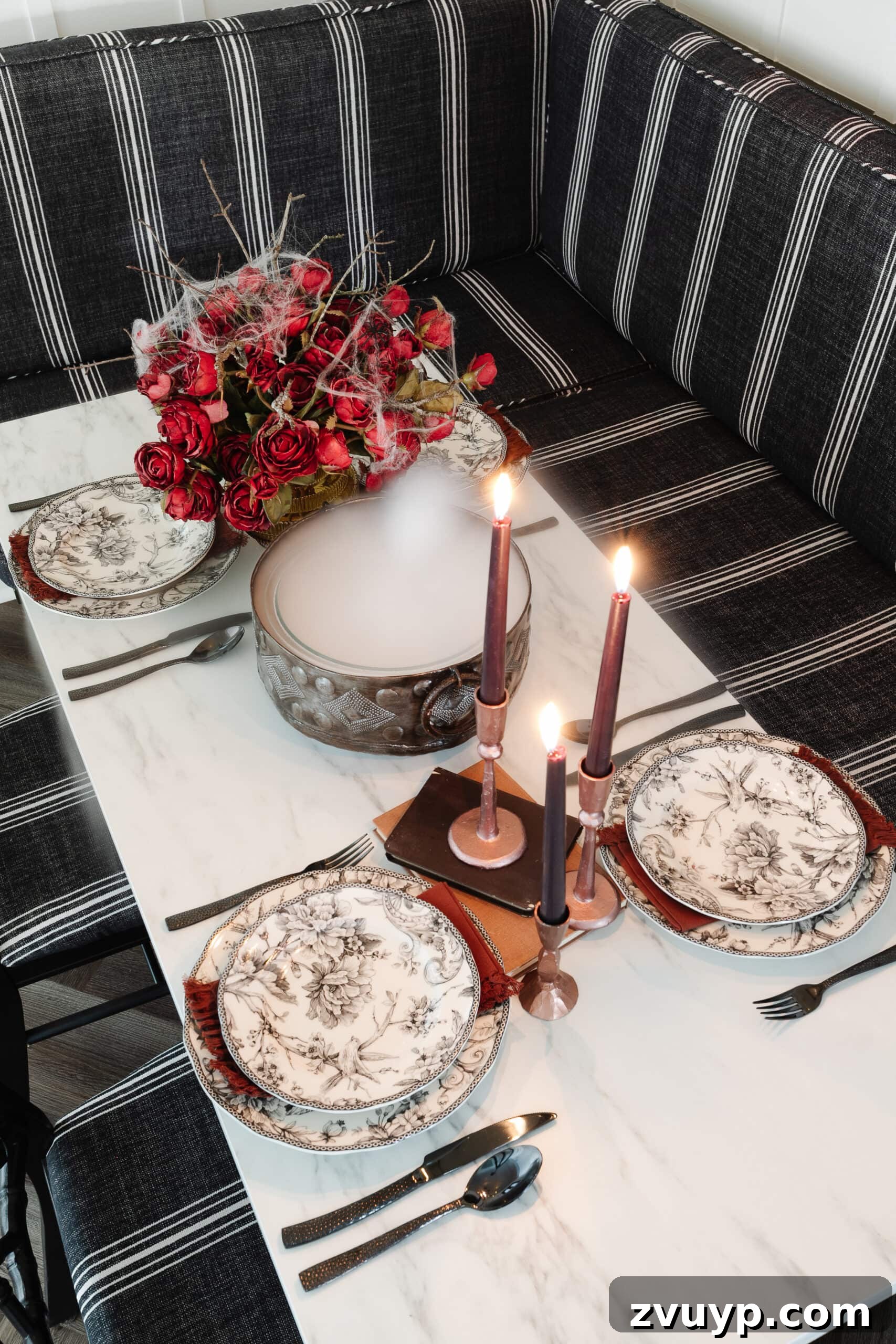 Killer Tablescapes for Your Halloween Murder Mystery 4 murder mystery party table decor with black toile dinnerware, cauldron of dry ice fog, and red roses with spider webs