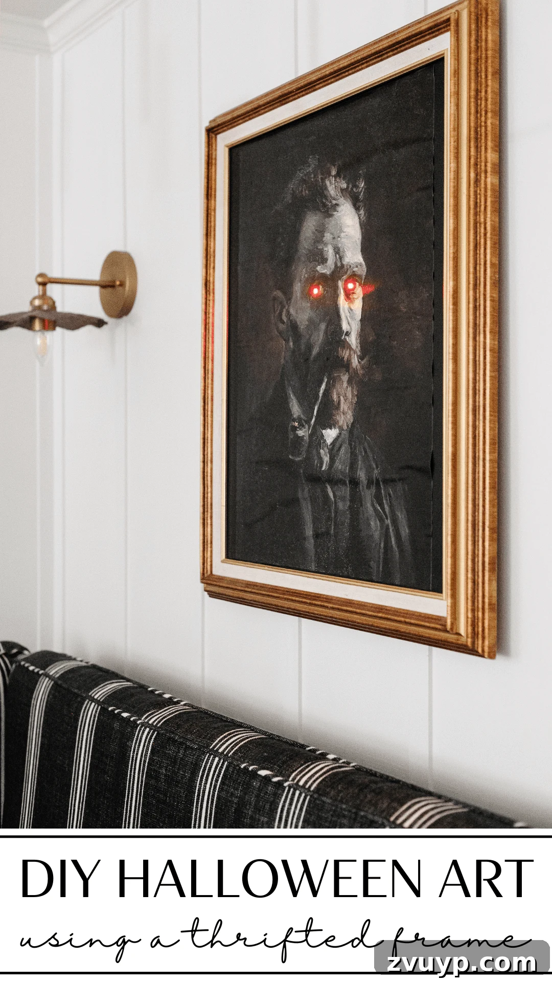 DIY creepy Halloween art in a thrift store frame with glowing eyes for unique wall decor