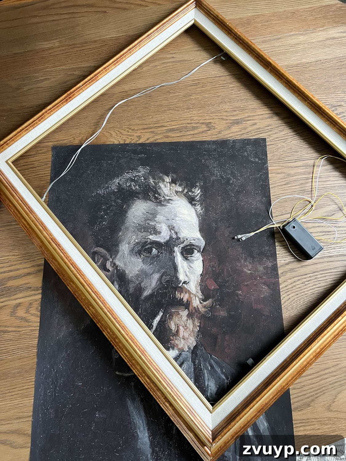 Thrifted picture frame, art print, and battery operated lights for DIY creepy art