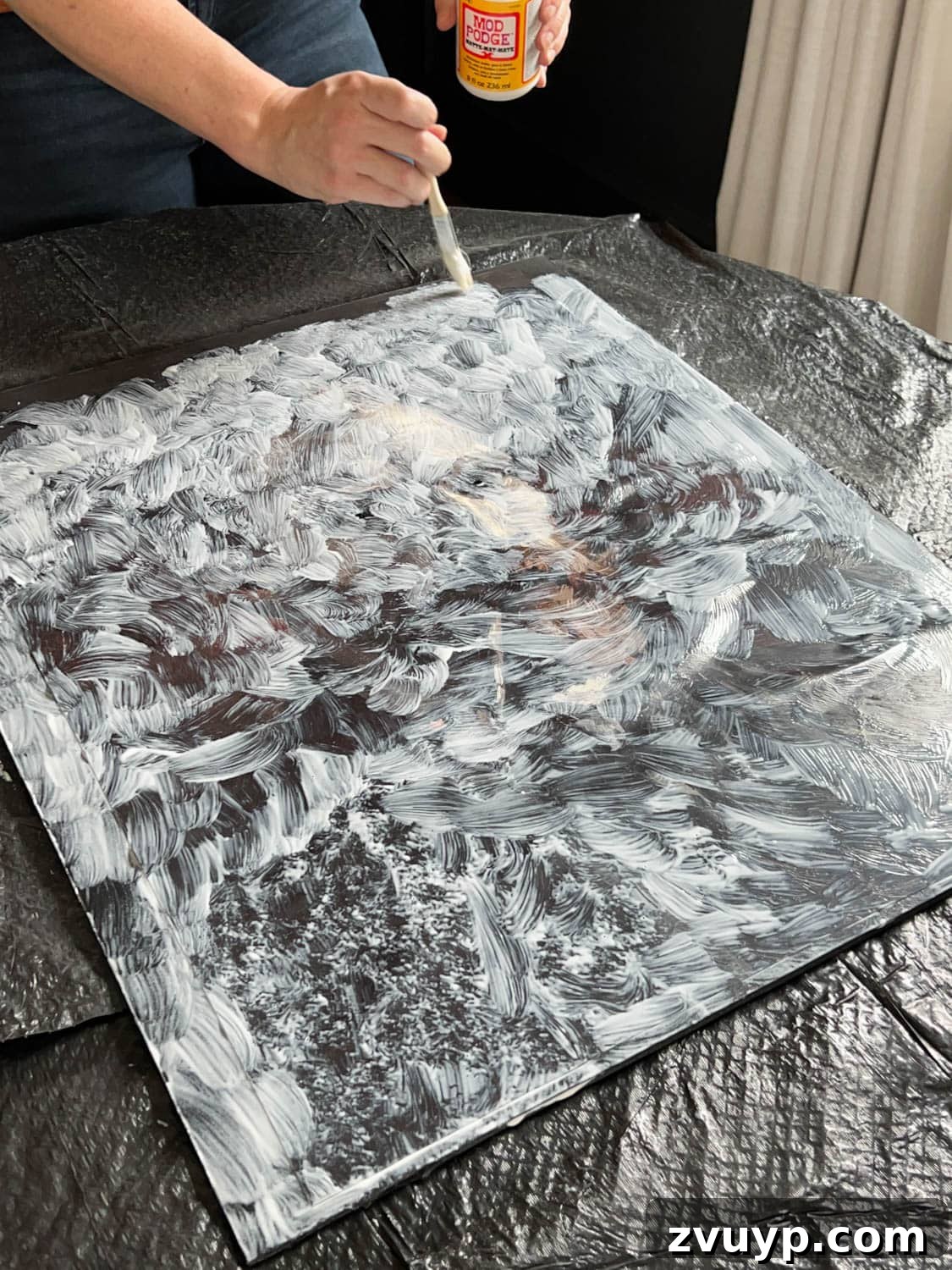 Mod Podge brushed onto an art printable to look like brush stroke texture, enhancing its vintage appearance.