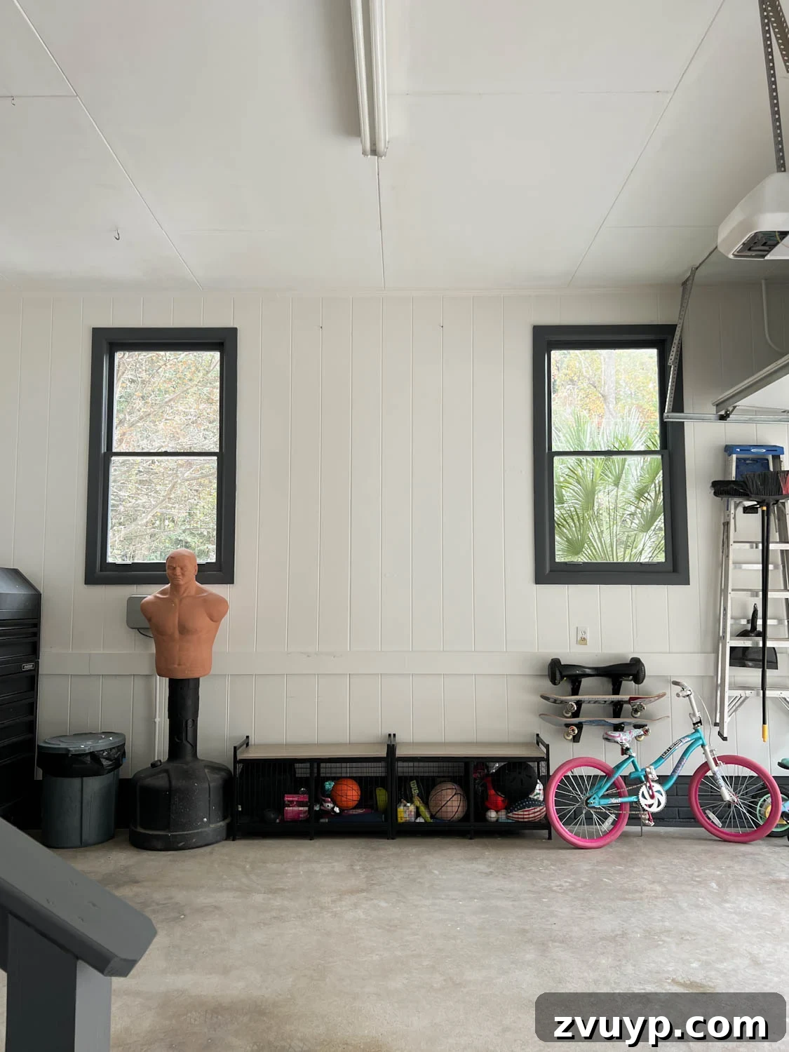 Reclaim Your Garage Space with Smart Storage 6 garage makeover after with white walls and black trim
