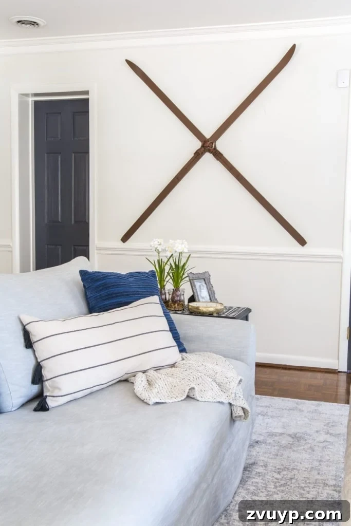 Deck Your Walls: 18 Festive Christmas Decor Ideas & Printable Holiday Art 12 Christmas wall decor idea featuring vintage-style snow skis hung on a wall for a rustic festive look