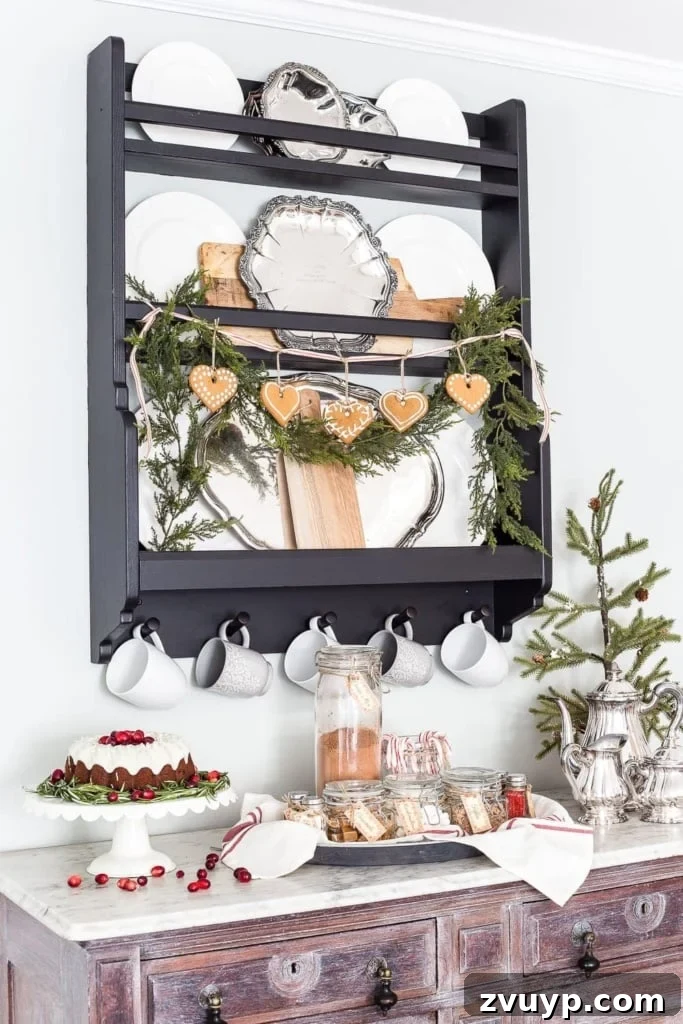 Deck Your Walls: 18 Festive Christmas Decor Ideas & Printable Holiday Art 13 Plate rack adorned with garland and gingerbread cookies, displayed in Scandinavian style for Christmas kitchen decor