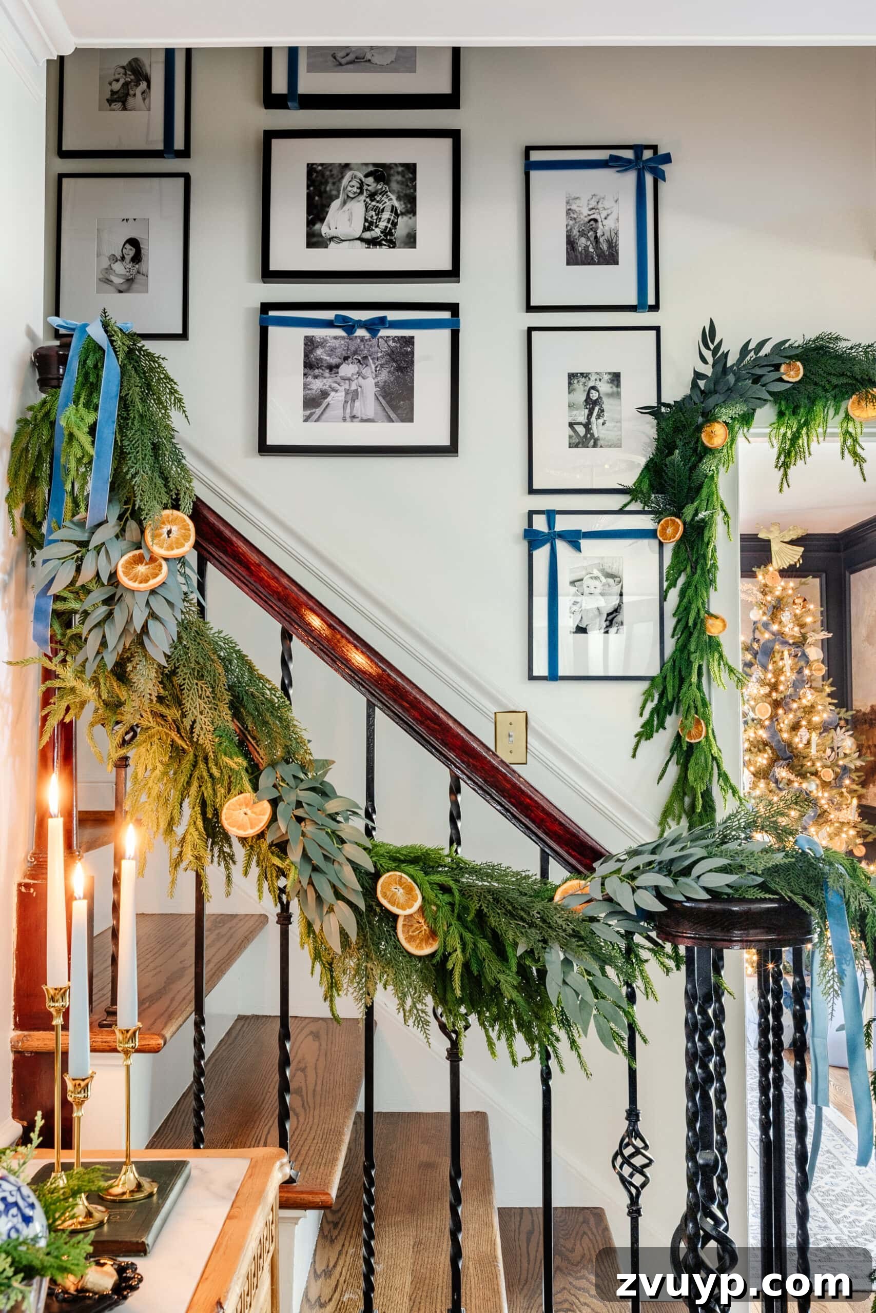 Easy 5-Minute Christmas Bow Craft 2 Family photo gallery wall adorned with festive Christmas bows ascending a staircase, showcasing easy ribbon art transformation.