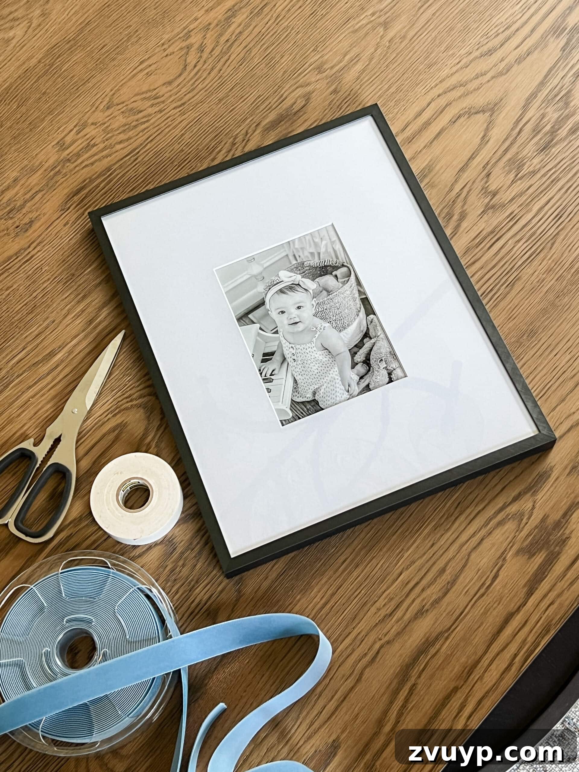 Easy 5-Minute Christmas Bow Craft 3 Essential supplies laid out for crafting ribbon art, including ribbon, tape, scissors, and a picture frame.
