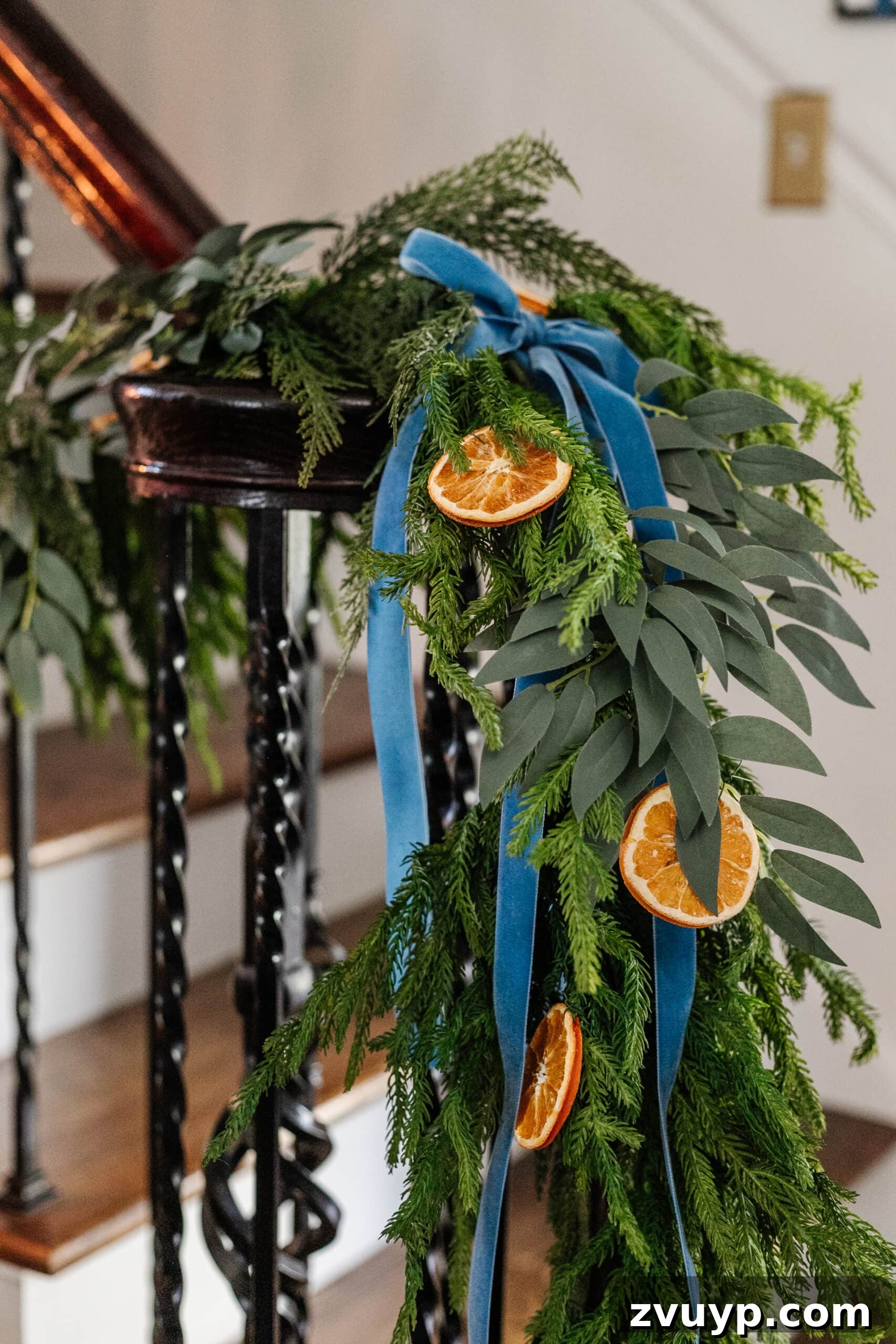 Deck the Halls Staircase and Entryway Christmas Garland Decor 13 garland with dried oranges, eucalyptus, and blue ribbon
