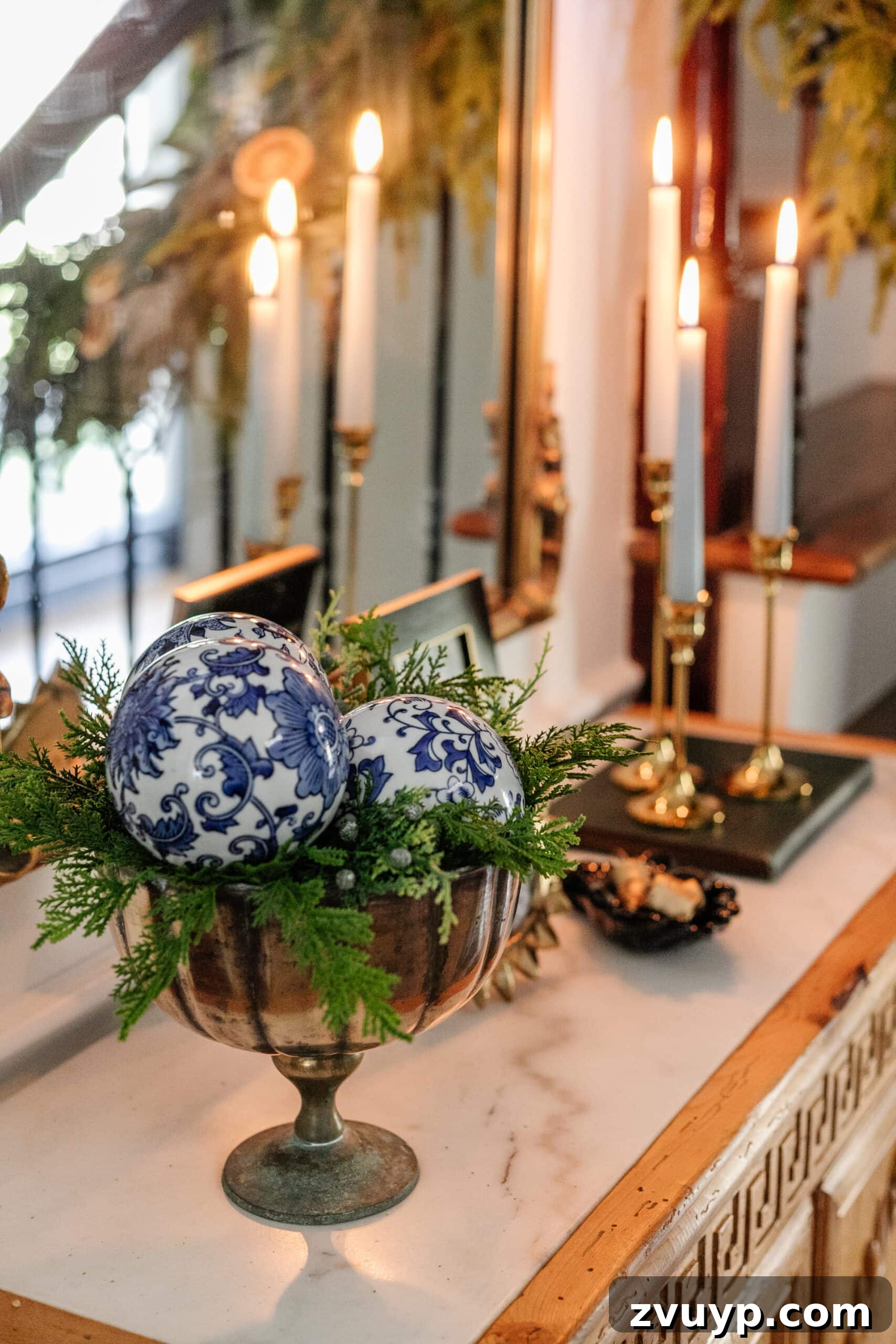 Deck the Halls Staircase and Entryway Christmas Garland Decor 17 porcelain orbs in a footed bowl with greenery on an entryway table for blue and white Christmas decor