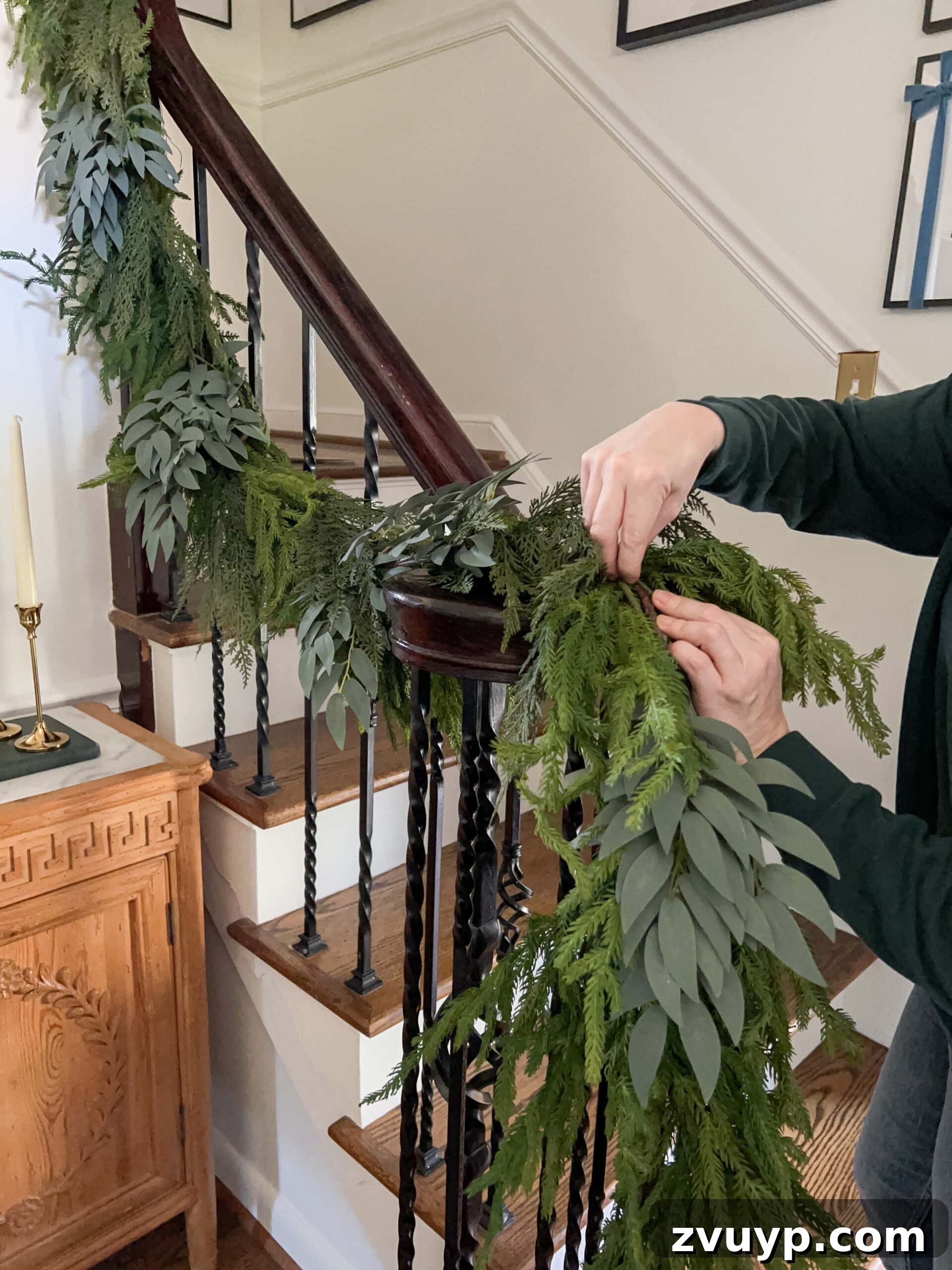 Deck the Halls Staircase and Entryway Christmas Garland Decor 9 mixing leafy stems into artificial garland to make it look real