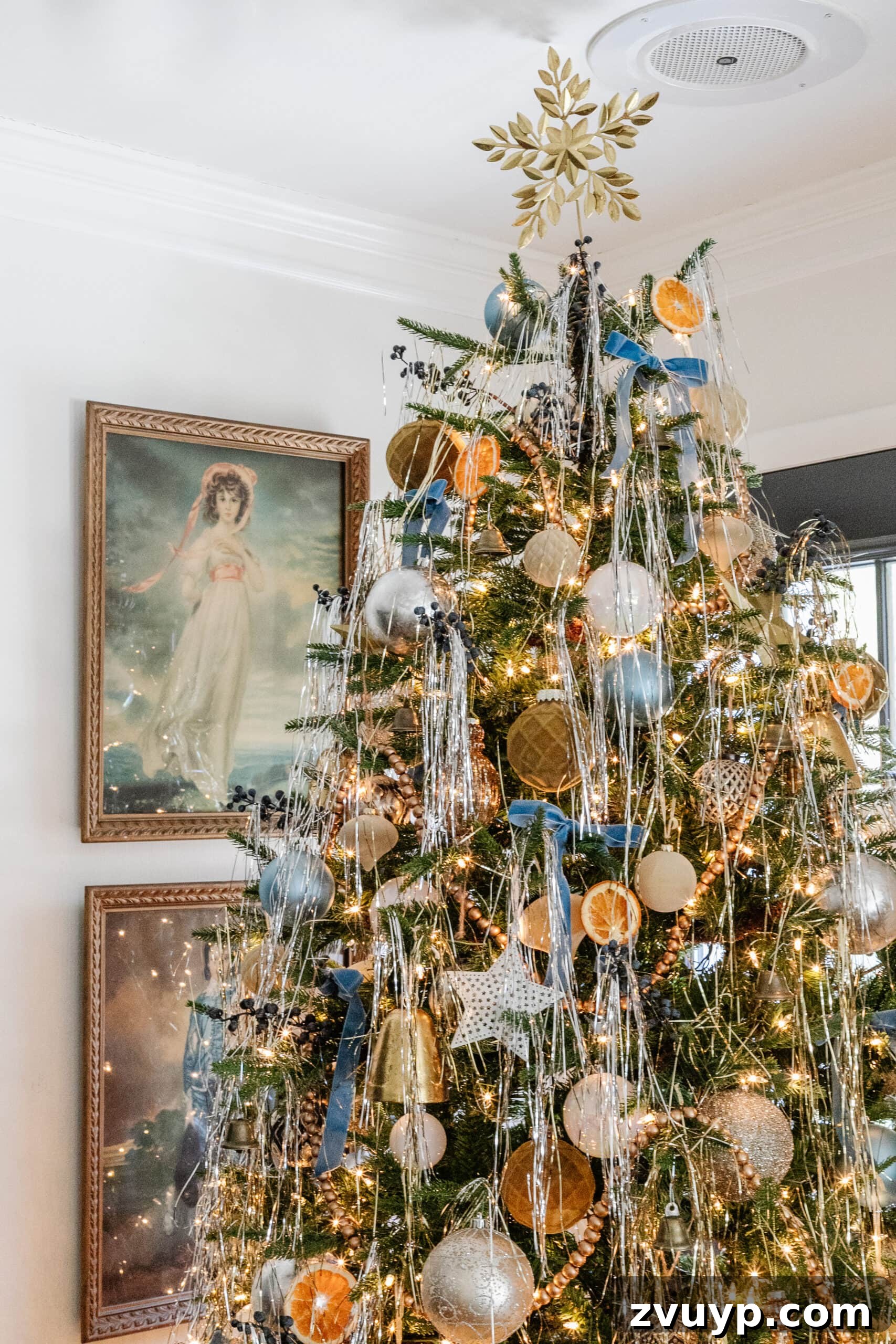 Festive Comfort: Living Room Decor for a Magical Christmas 14 Classic 'Pinkie and Blue Boy' art displayed beside a beautifully decorated Christmas tree, adding an elegant and traditional touch to the holiday living room.