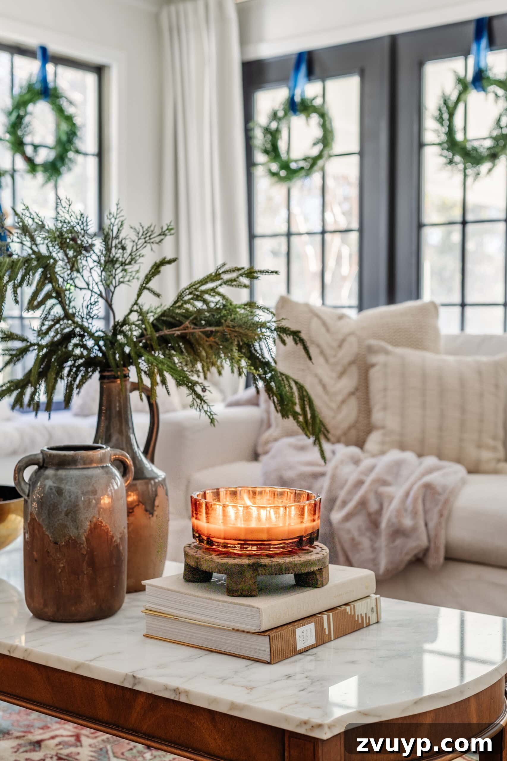 Festive Comfort: Living Room Decor for a Magical Christmas 7 A lit candle surrounded by elegant winter decor on a coffee table, setting a cozy Christmas mood.