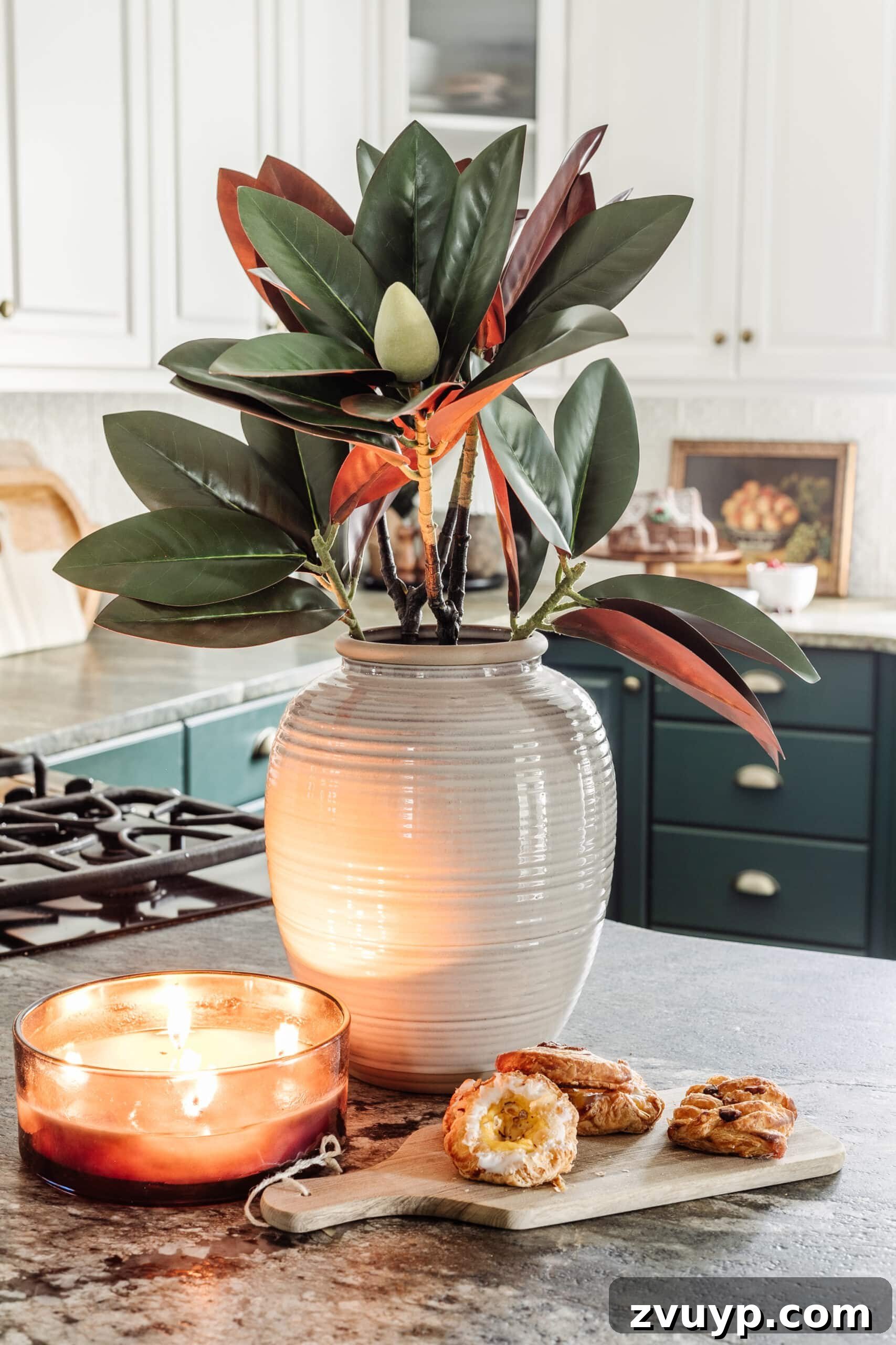 9 Quick Christmas Kitchen Transformations 12 stem of magnolia stems in a vase on a kitchen countertop decorated for Christmas