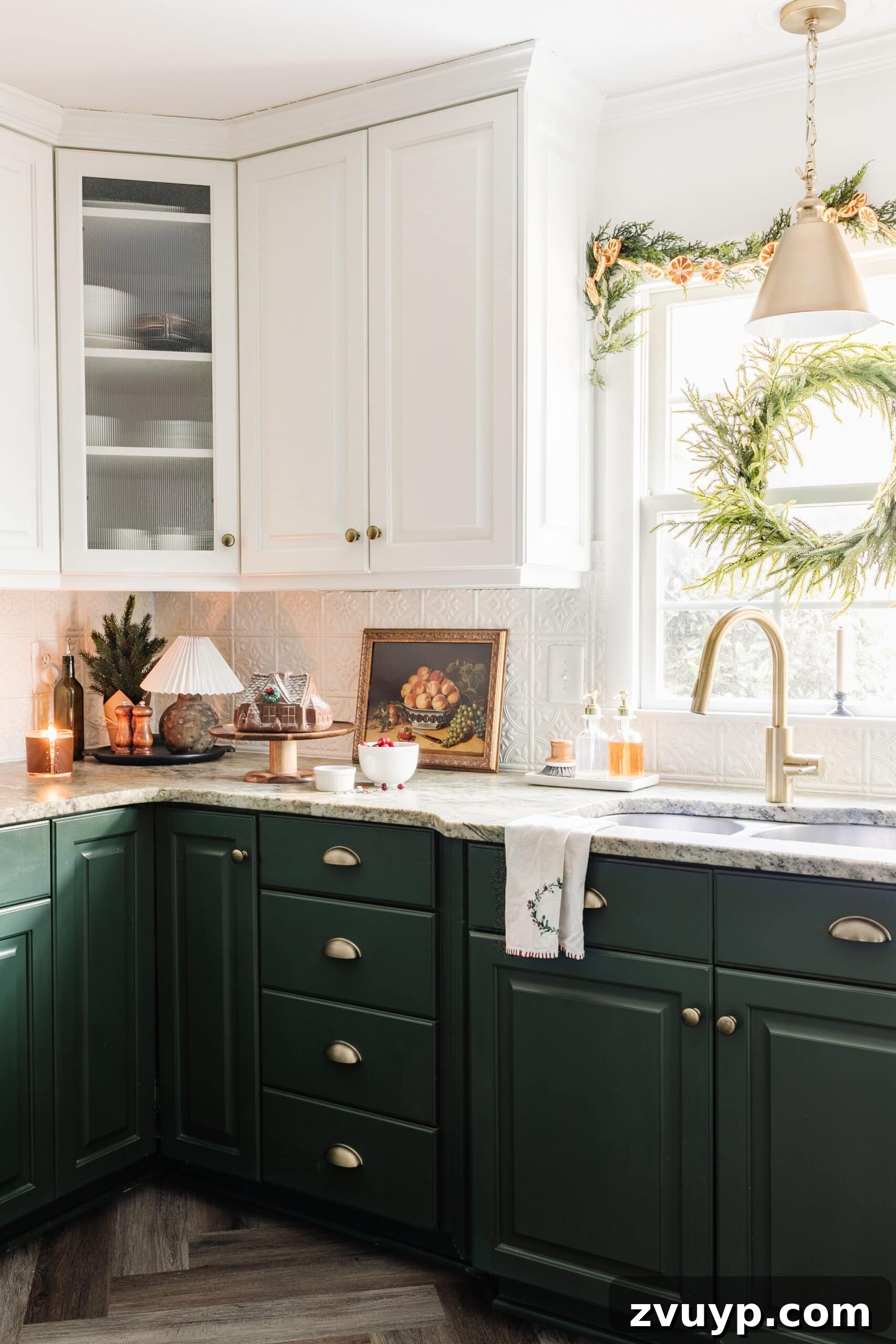 9 Quick Christmas Kitchen Transformations 8 Christmas decor on a kitchen countertop and wreath and garland on window adding festive light