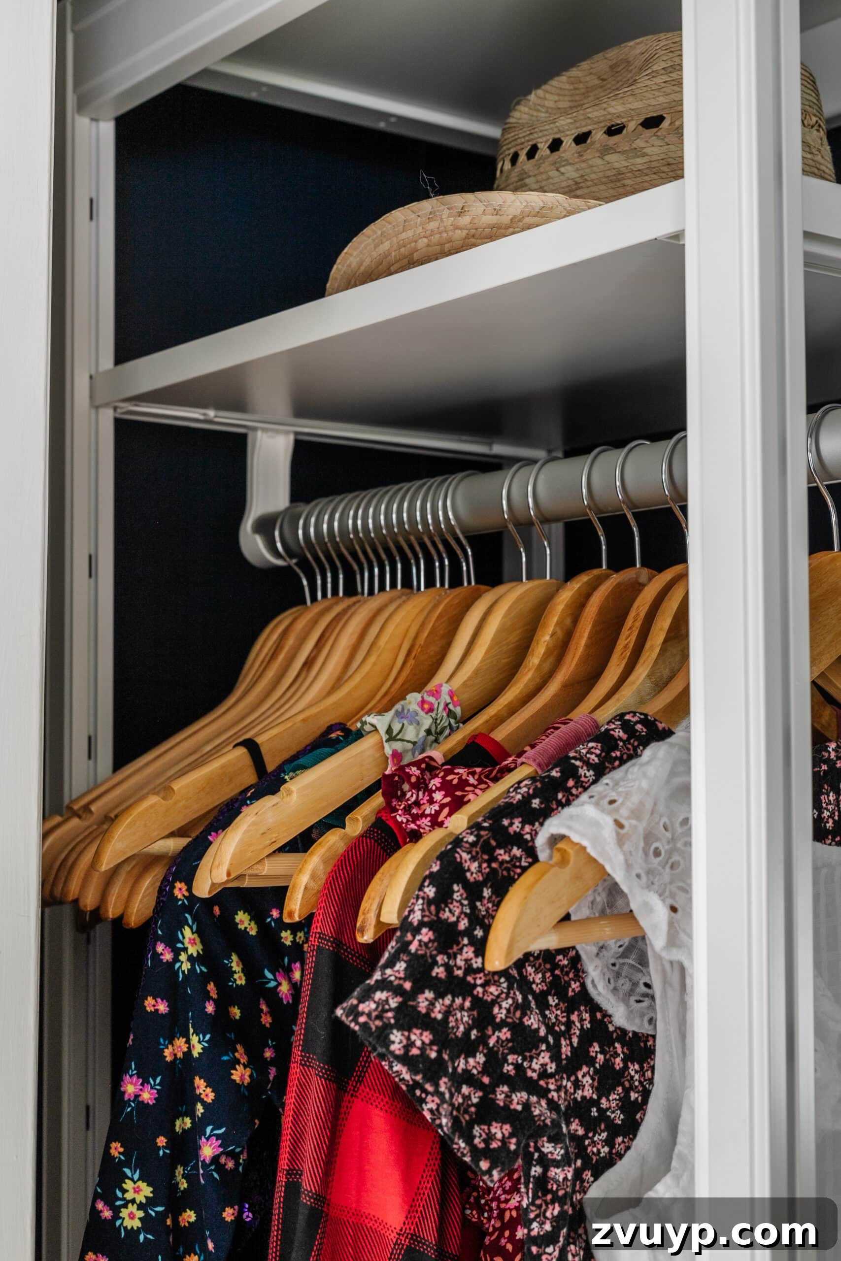 Girl's Guide to a Tidy Tiny Closet: 10 Smart Ideas 13 matching wooden hangers on a rod to minimize clutter