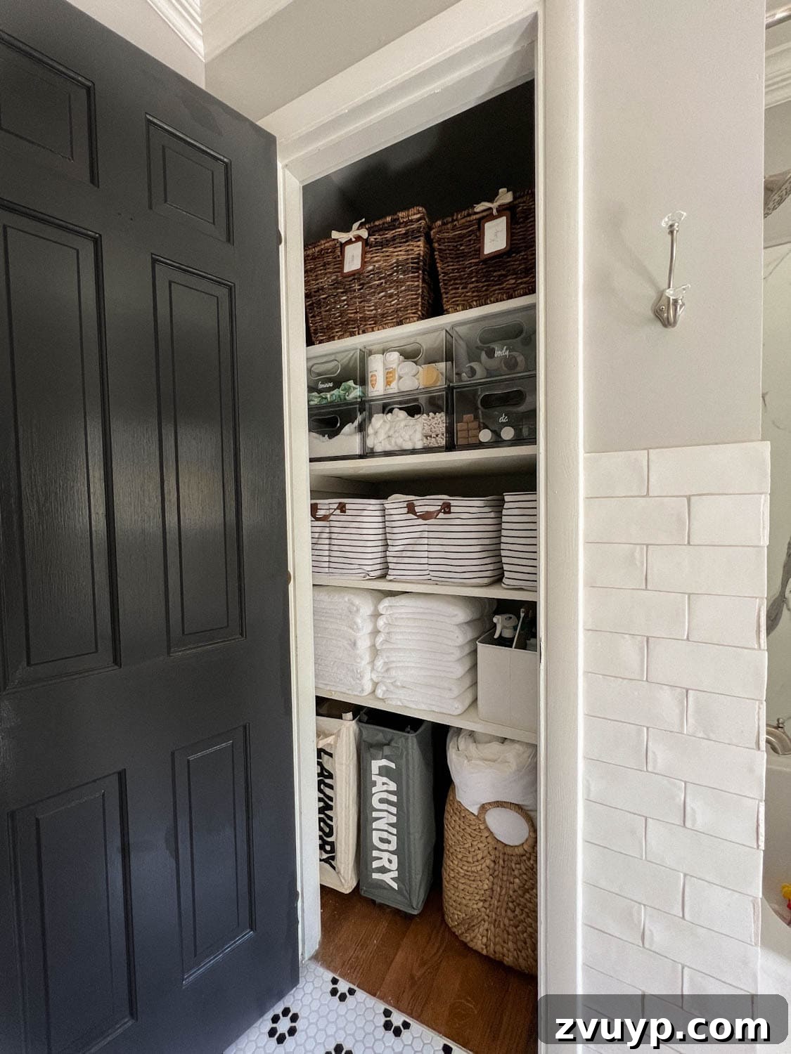Conquer Clutter Fast: Insider Secrets for a Tidy Home 2 Organized linen closet featuring white towels, baskets, and neatly stacked essentials, showcasing effective decluttering methods.