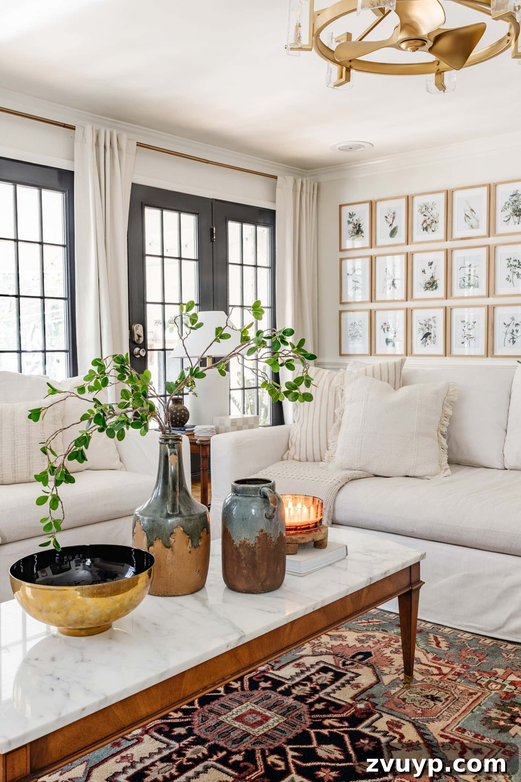 Winter Warm-Up: Easy Decor for a Cozy Retreat 12 Winter living room January decor with white sofas, a glowing candle, and a vase of greenery on the coffee table