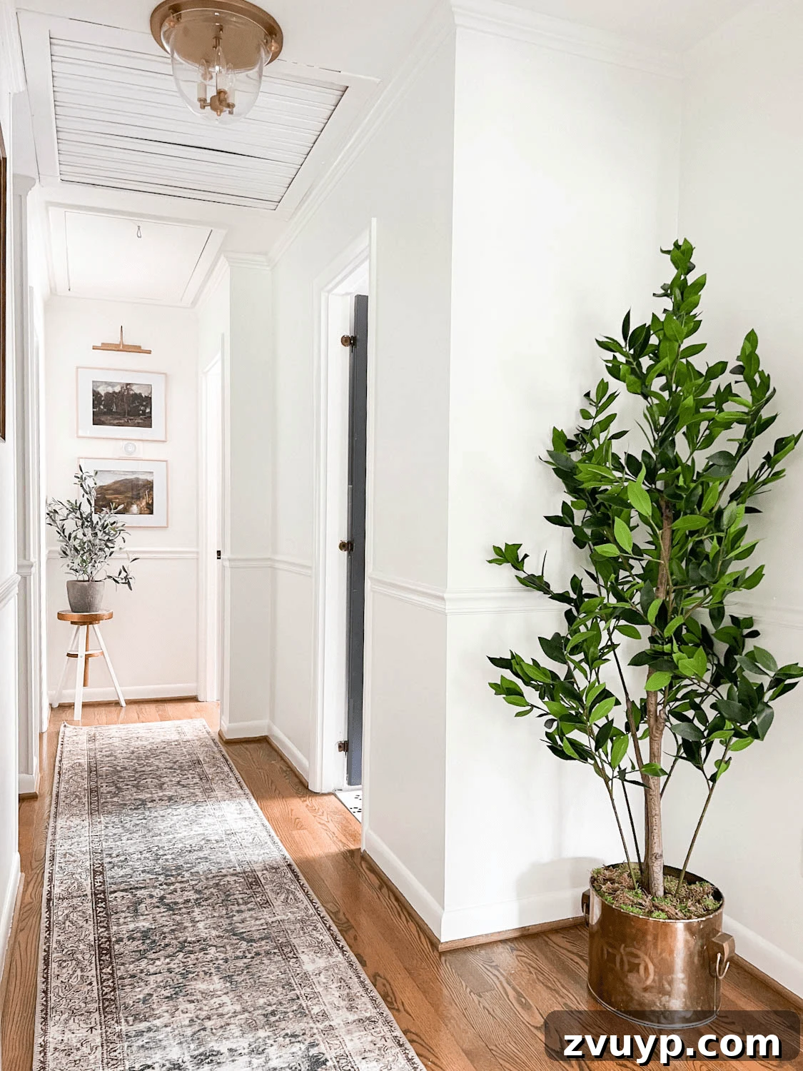 Winter Warm-Up: Easy Decor for a Cozy Retreat 5 Elegant hallway decor featuring a realistic faux potted plant and a stylish runner rug