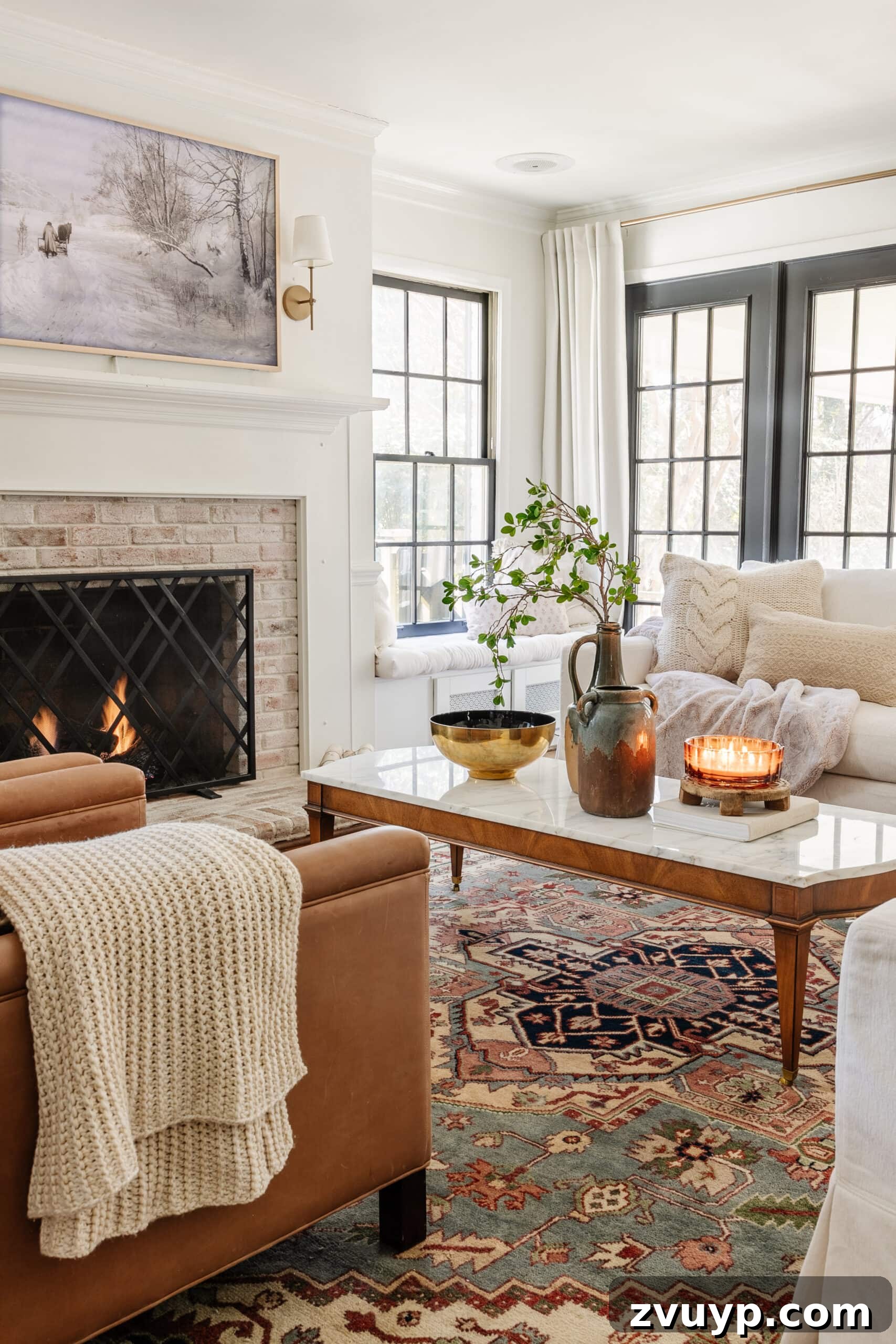Winter Warm-Up: Easy Decor for a Cozy Retreat 8 Cozy January living room with a simple fireplace, serene snow art, and chunky knit blankets