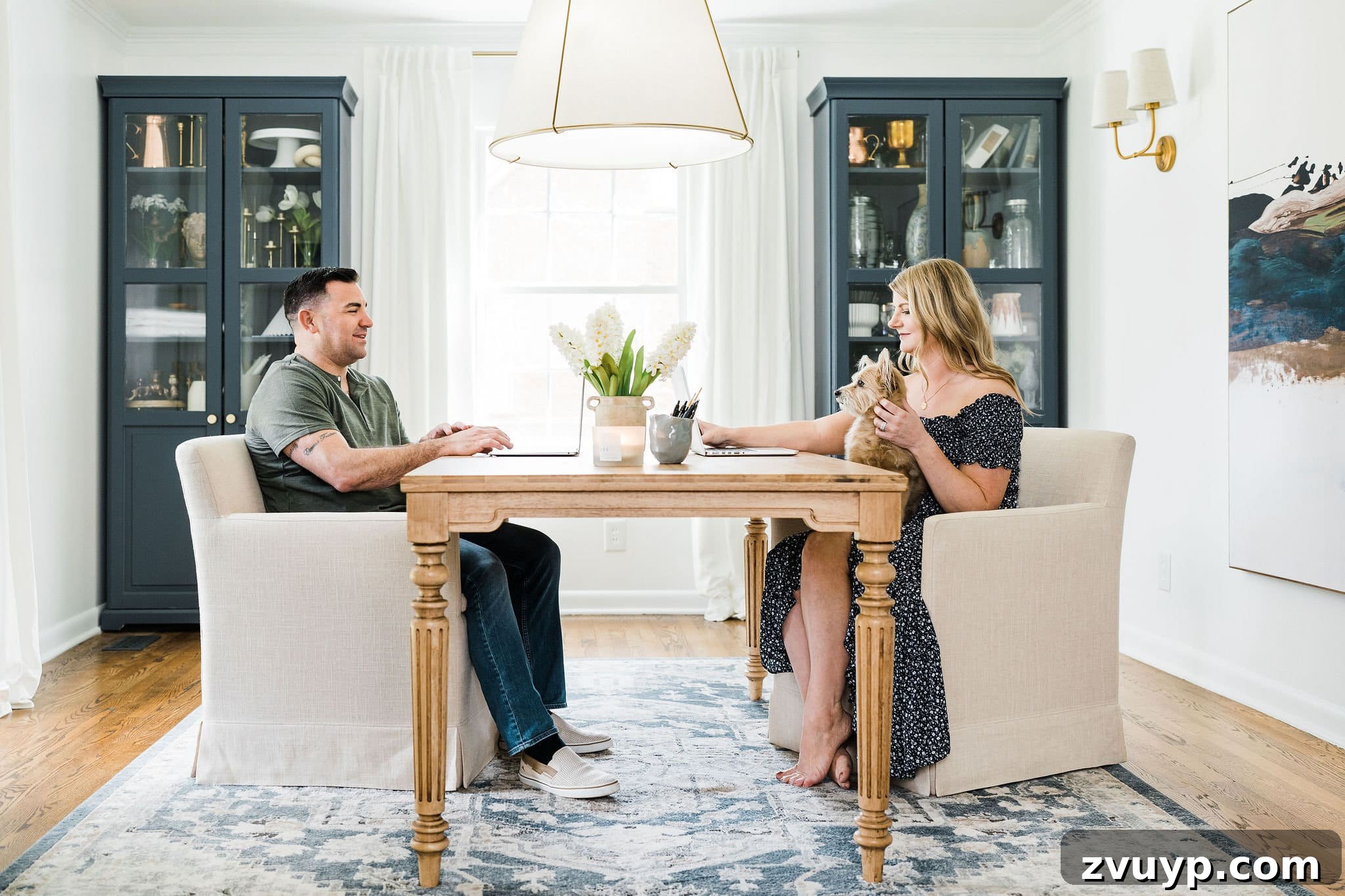 Step Inside a Historic Colonial Home 2023 2 A beautifully organized home office for two, featuring a shared desk, two comfortable desk chairs, and ample storage cabinets, showcasing efficient and stylish design within a modern traditional colonial home.