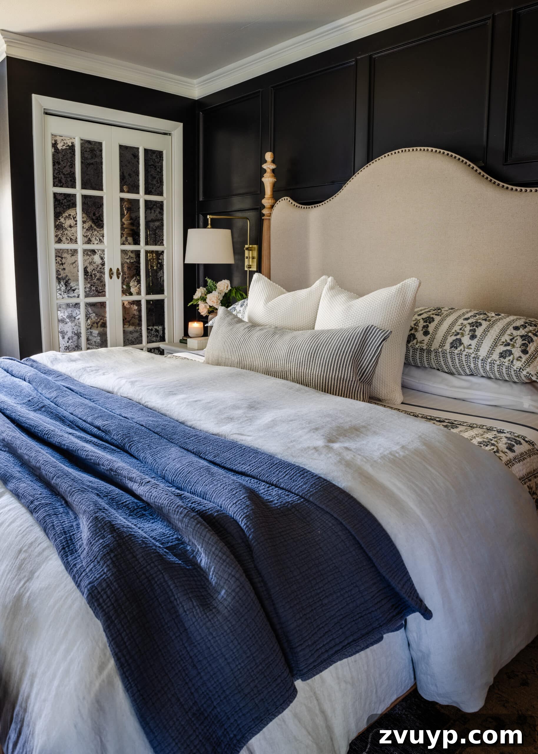 Parisian Chic on a Shoestring Budget 11 Stylish white French door bifold doors on a closet, enhanced with antique mirror effect film, adding privacy and classic Parisian charm to a bedroom.