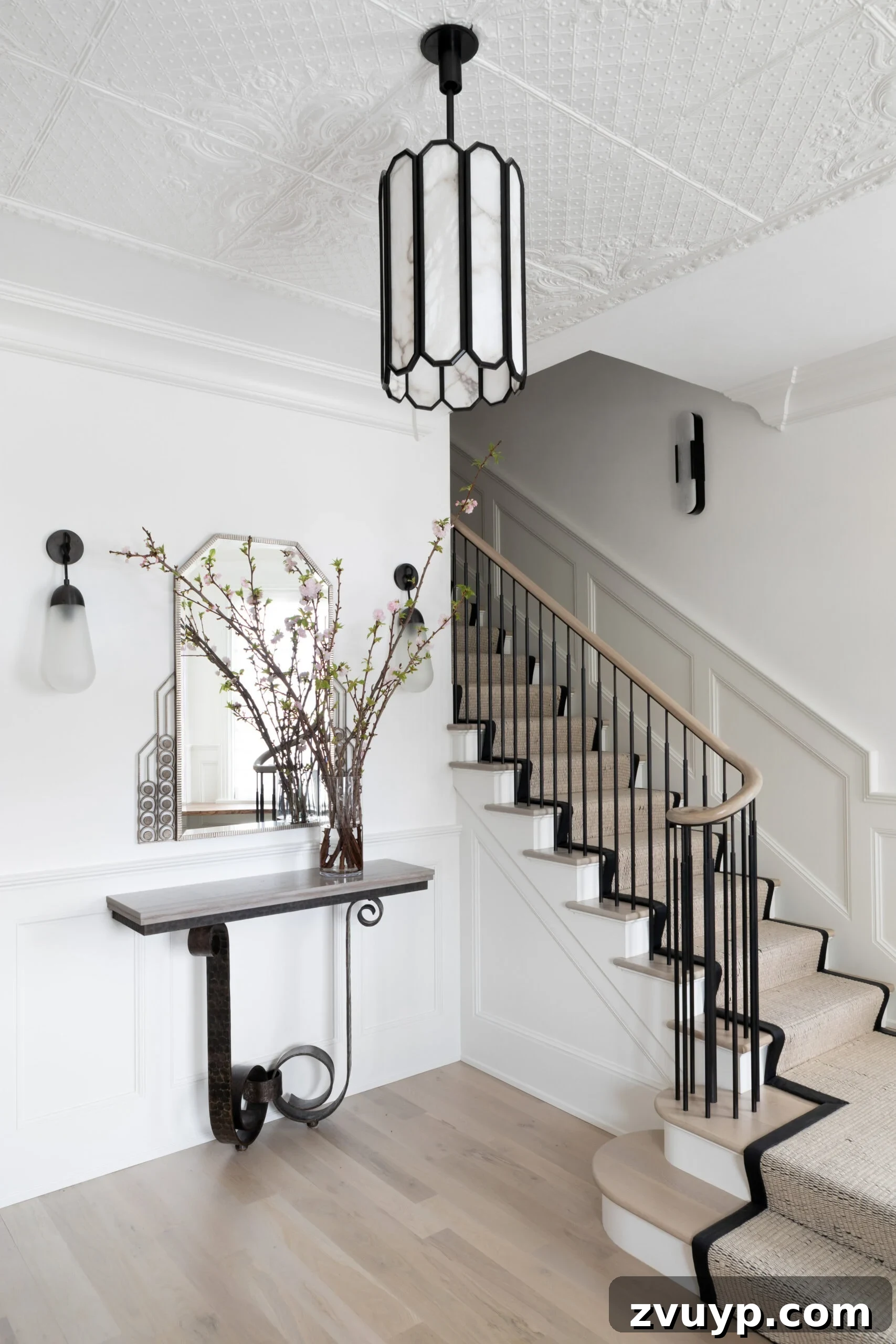 Elevate Your Foyer: 9 Dramatic Black Stair Railing Designs 5 elegant entryway staircase with wood handrail and simple black balusters