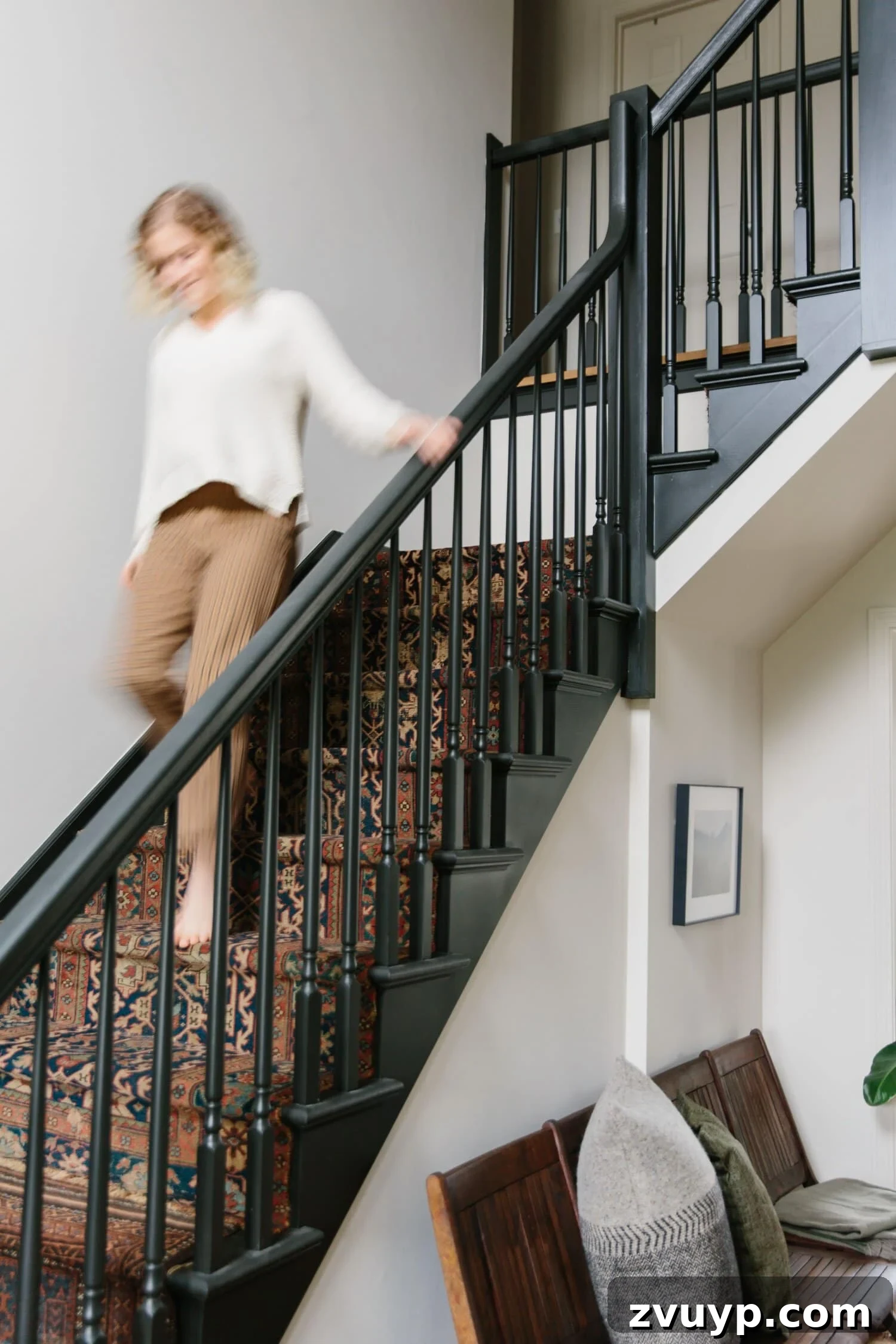 Elevate Your Foyer: 9 Dramatic Black Stair Railing Designs 10 black painted staircase with vintage rug