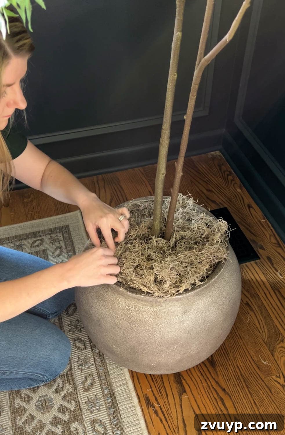 Realistic Artificial Trees: Expert Tricks for Indoor Authenticity 5 placing a fake tree in a large planter with moss to look real