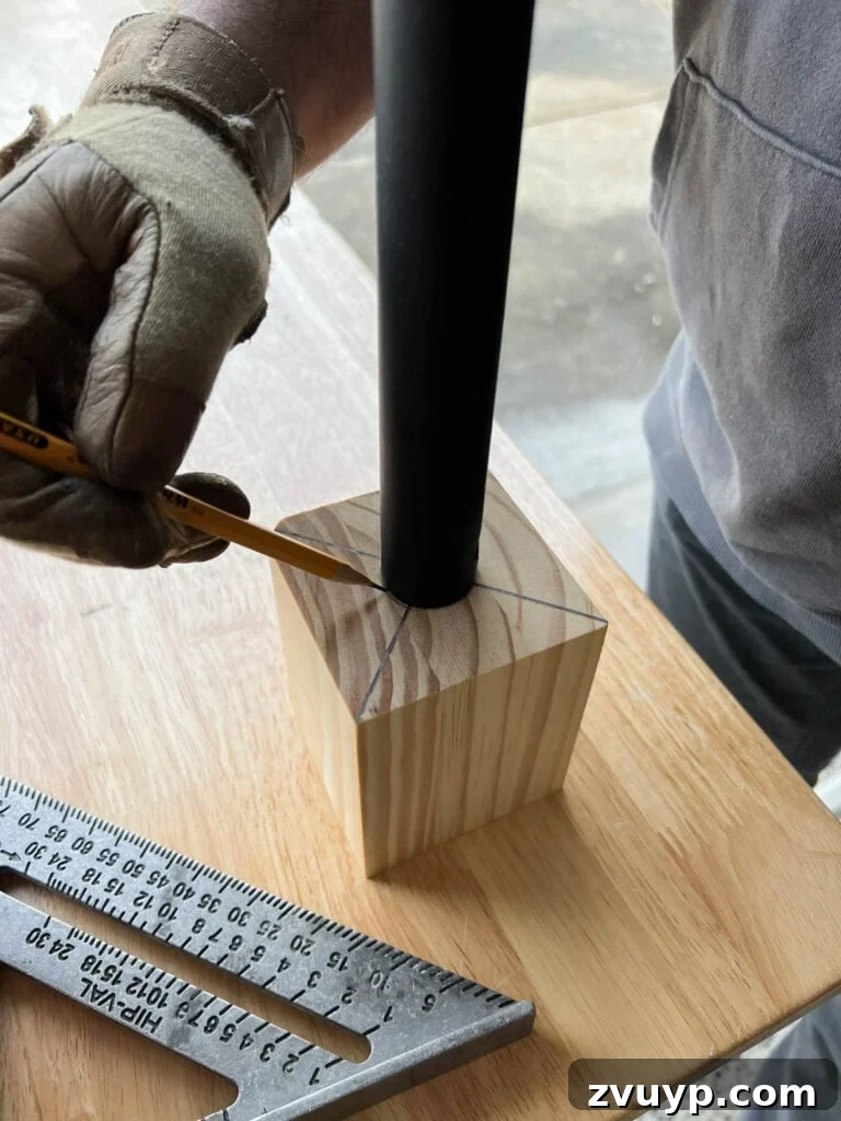 DIY Stair Spindle Swap For A Modern Makeover 19 Marking the center point on a wood block for a new newel post mount