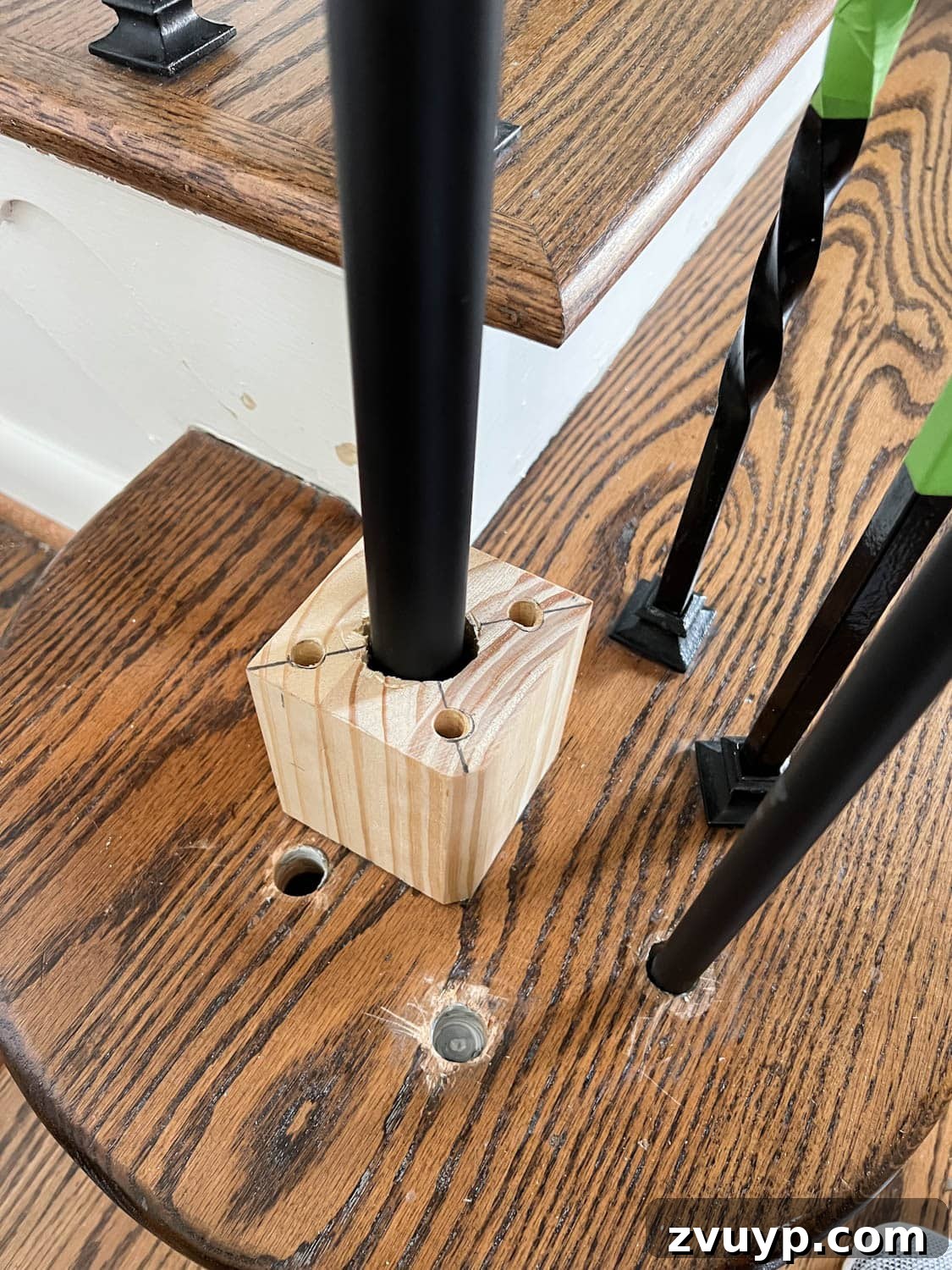 DIY Stair Spindle Swap For A Modern Makeover 21 Installing a new newel post onto a wood block mount, showing secure attachment