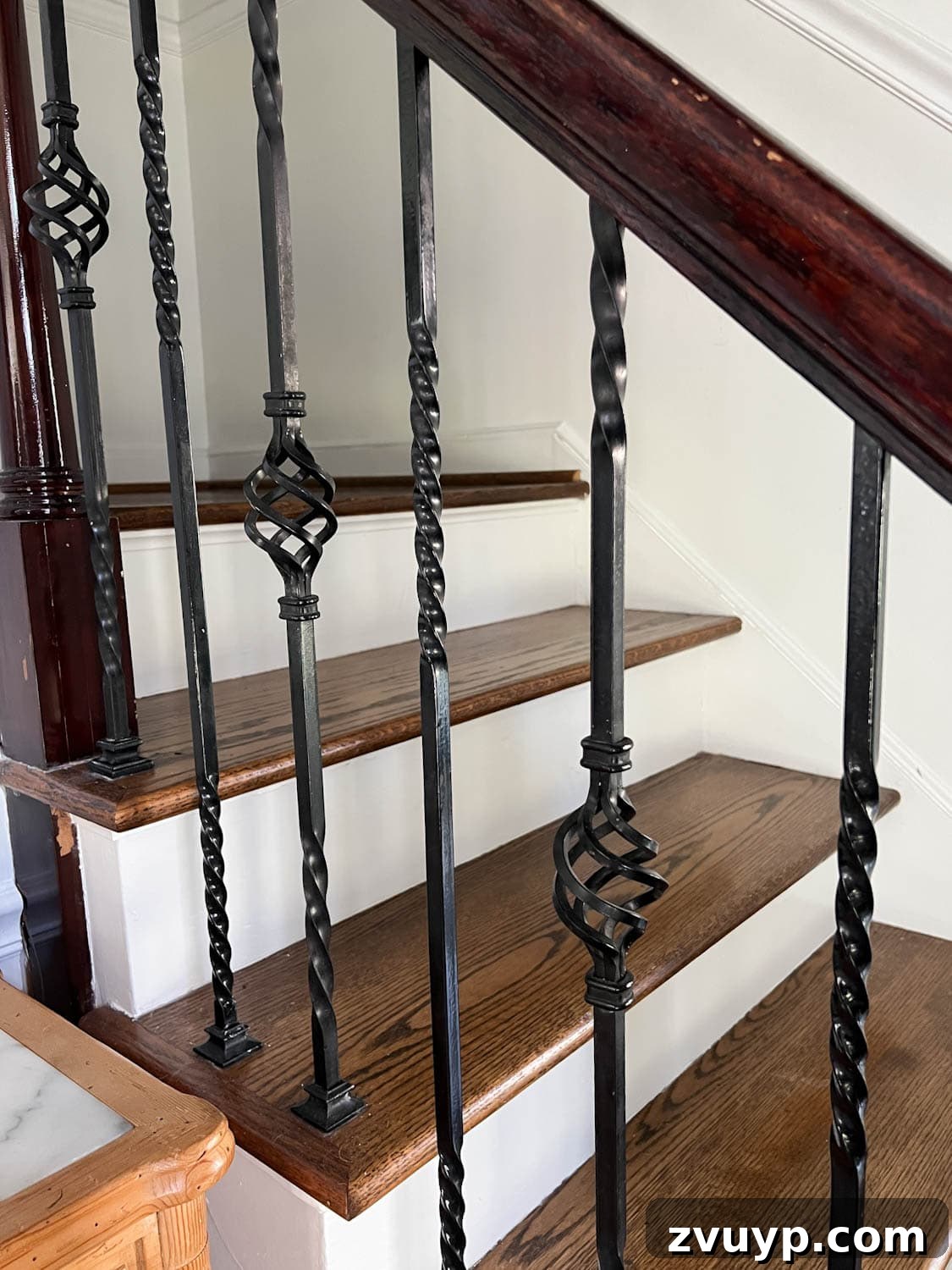 DIY Stair Spindle Swap For A Modern Makeover 6 Close-up of the intricate twisted wrought iron stair balusters before renovation