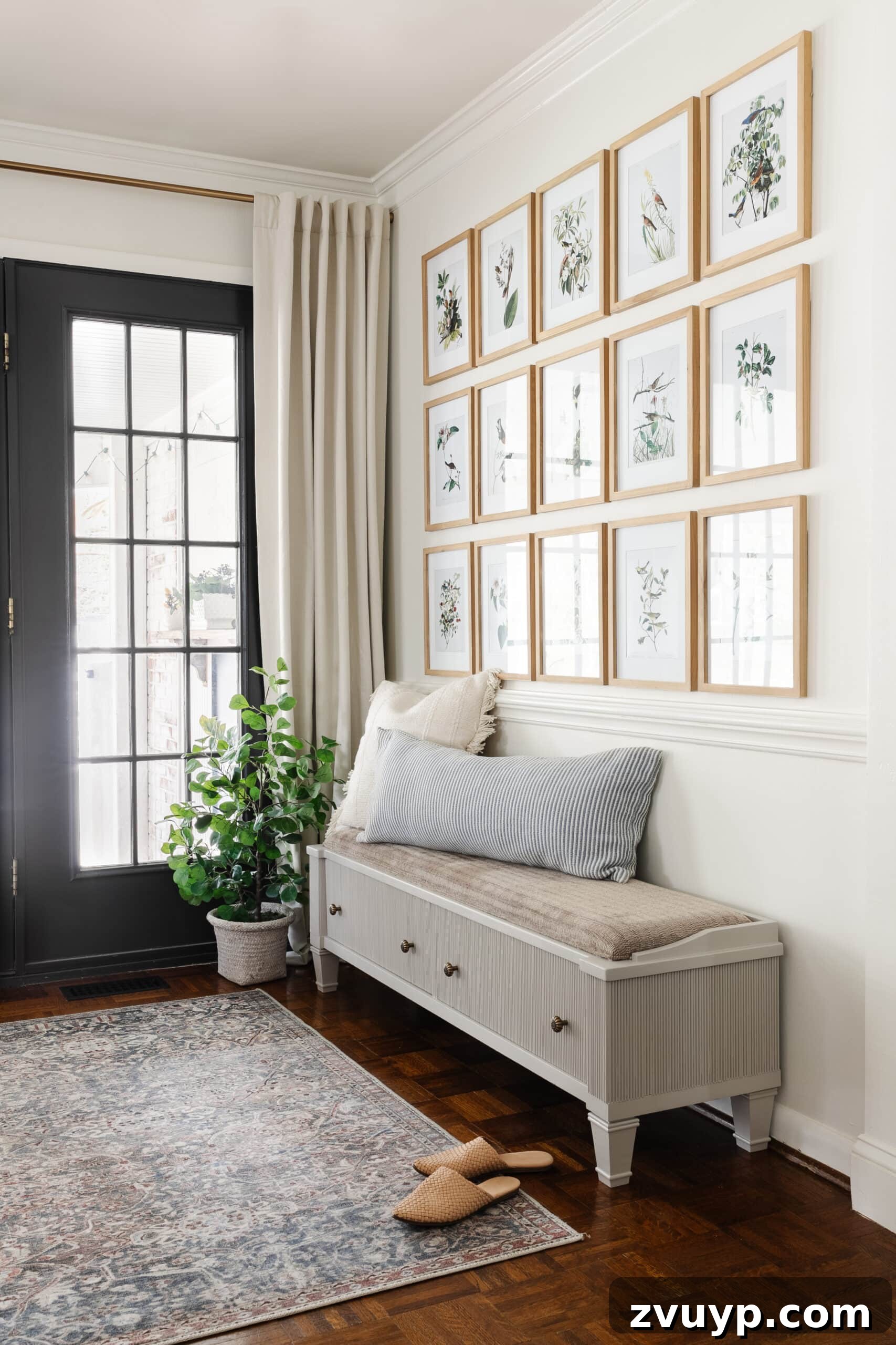 From Bland to Grand The Reeded Shoe Bench Makeover 20 A reeded bench anchors an entryway featuring an elegant Audubon bird art gallery wall, creating a cohesive and stylish welcome.