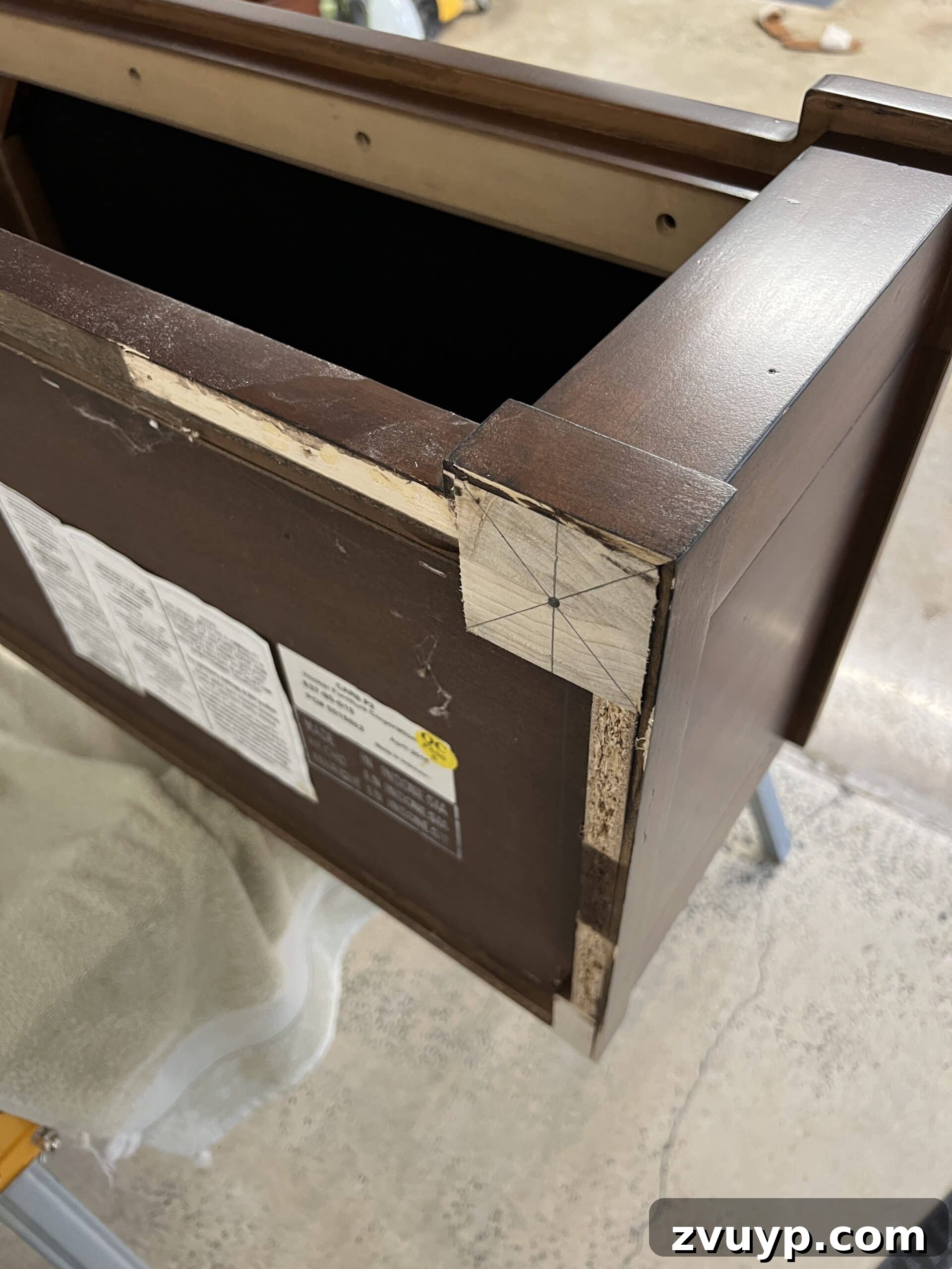 From Bland to Grand The Reeded Shoe Bench Makeover 8 A pencil and speed square are used to mark precise placement points on the bottom of the bench for new furniture legs, ensuring accurate alignment.