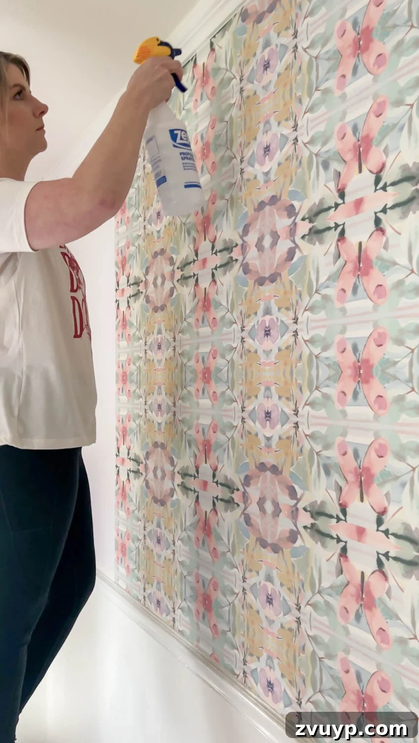 Mastering Wallpaper Removal: 3 Tried and True Methods 13 Spraying vinegar solution onto wallpaper for removal